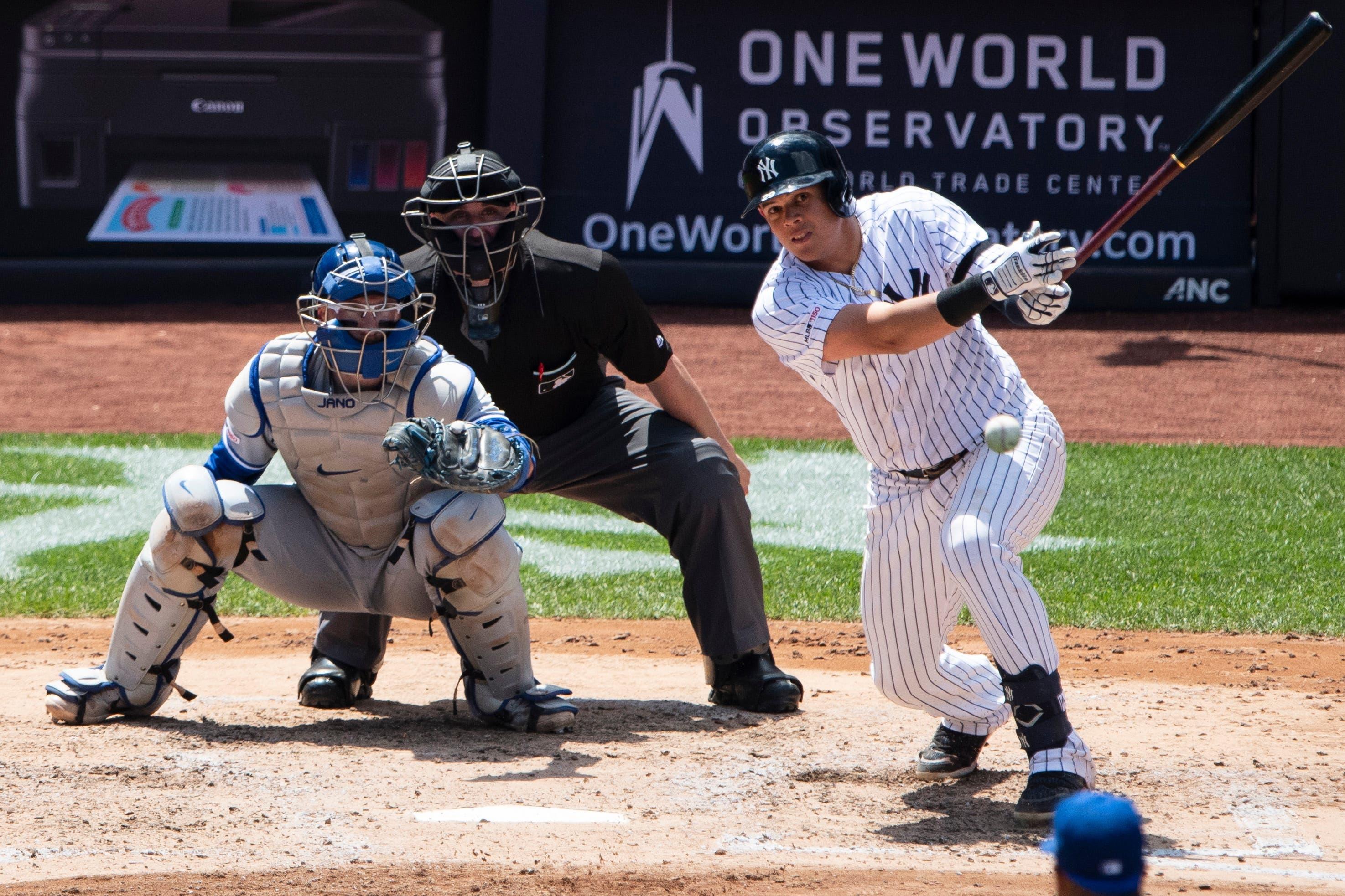 New York Yankees third baseman Gio Urshela hits an infield single against the Toronto Blue Jays during the fifth inning at Yankee Stadium. / Gregory Fisher/USA TODAY Sports