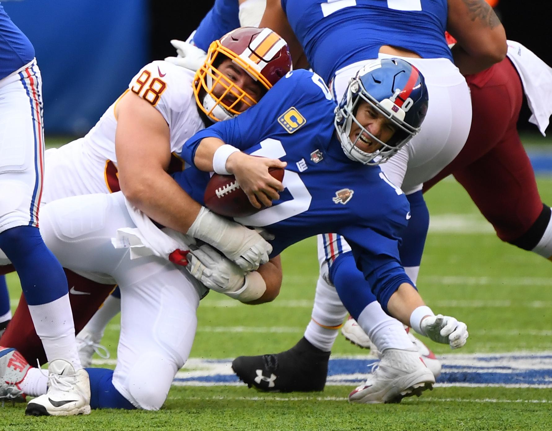 Washington Redskins defensive tackle Matt Ioannidis sacks New York Giants quarterback Eli Manning in the first quarter at MetLife Stadium.