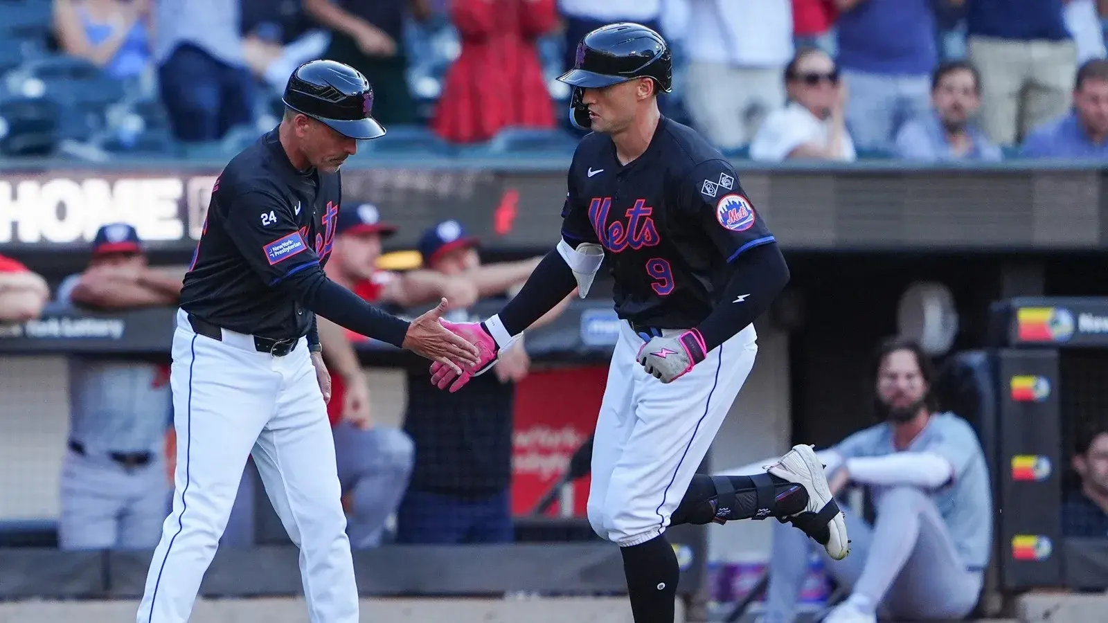 New York Mets third base coach Mike Sarbaugh (86) congratulates New York Mets left fielder Brandon Nimmo (9) for hitting a home run as he rounds the bases during the first inning at Citi Field. / Gregory Fisher-USA TODAY Sports