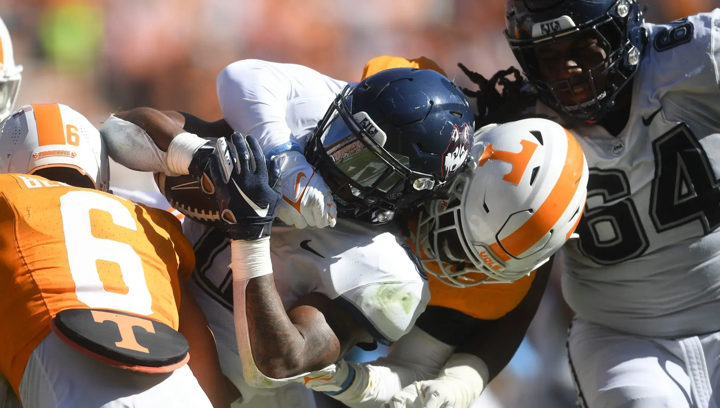 UConn running back Cam Edwards (0) is tackled by Tennessee defensive lineman Roman Harrison (30) during an NCAA college football game between Connecticut and Tennessee on Saturday, November 4, 2023 in Knoxville, Tenn. / Caitie McMekin/News Sentinel-USA TODAY NETWORK