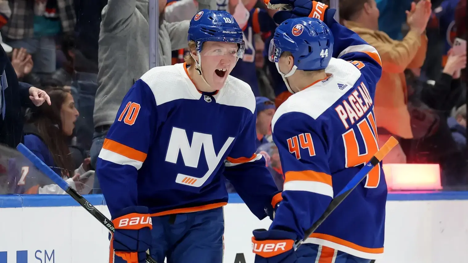Dec 19, 2023; Elmont, New York, USA; New York Islanders right wing Simon Holmstrom (10) celebrates his short handed goal against the Edmonton Oilers with center Jean-Gabriel Pageau (44) during the second period at UBS Arena. / Brad Penner-USA TODAY Sports