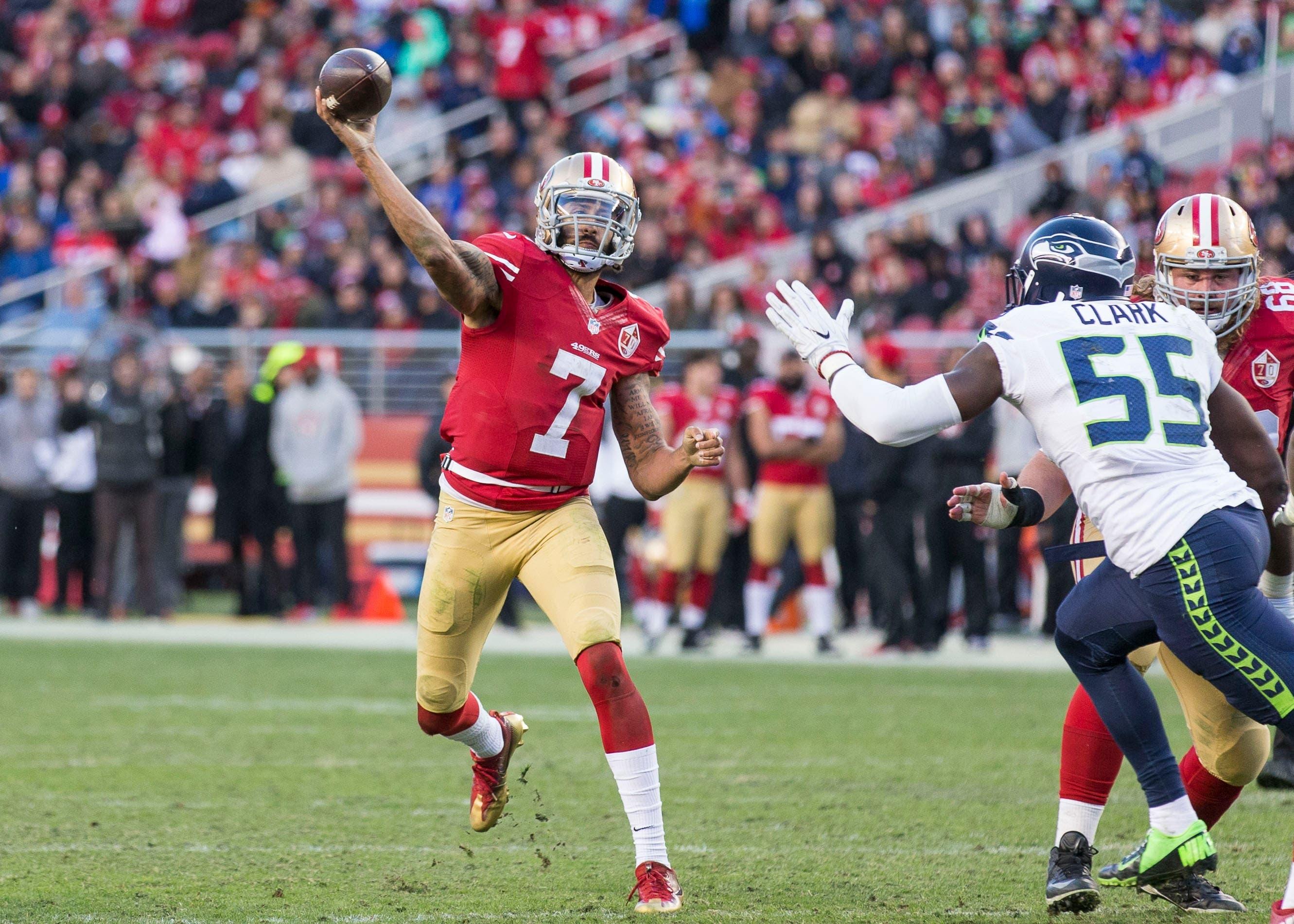 Jan 1, 2017; Santa Clara, CA, USA; San Francisco 49ers quarterback Colin Kaepernick (7) passes the football against Seattle Seahawks defensive end Frank Clark (55) during the fourth quarter at Levis Stadium Seahawks defeated the 49ers 25-23. Mandatory Credit: Neville E. Guard-USA TODAY Sports / Neville E. Guard