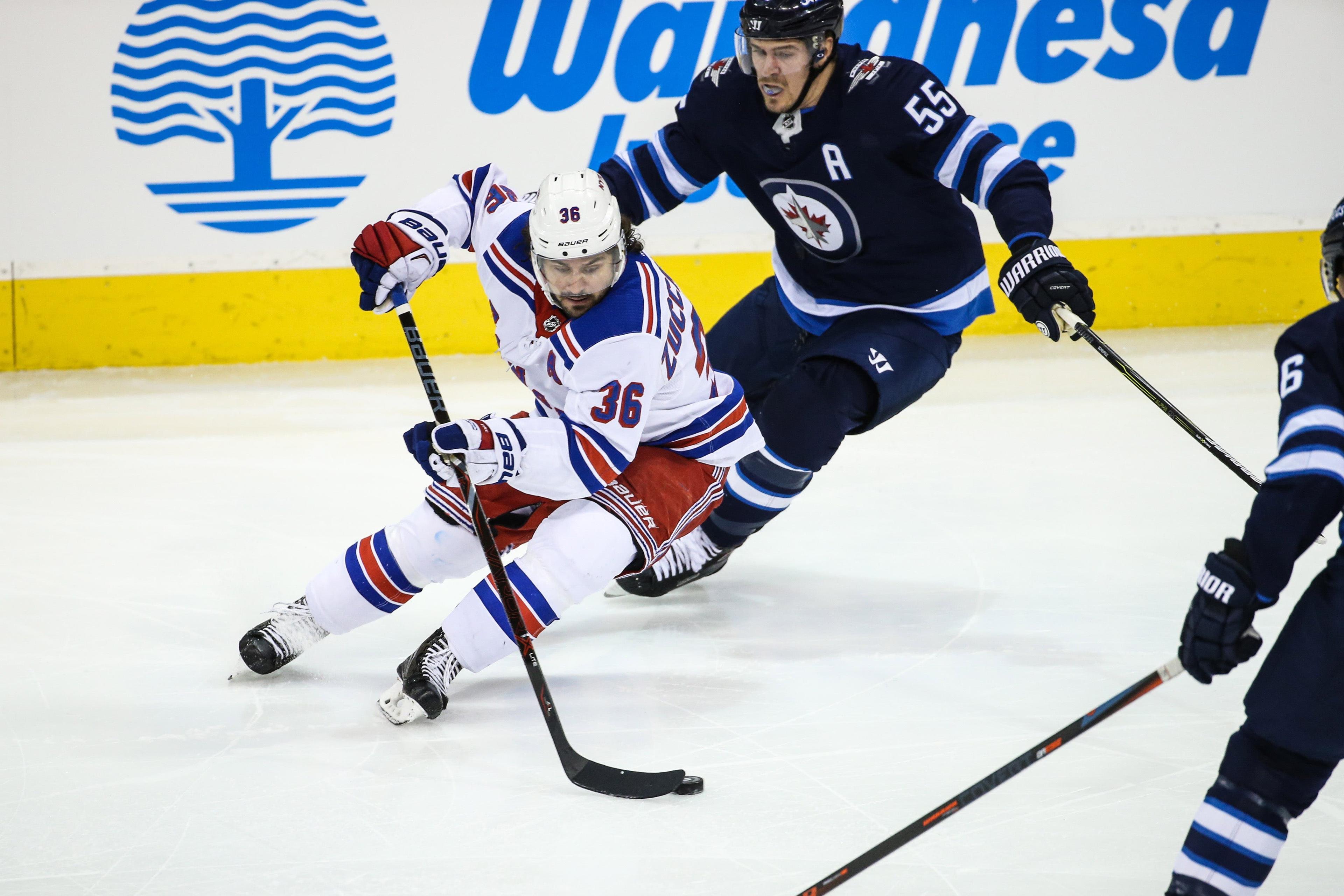 Feb 11, 2018; Winnipeg, Manitoba, CAN; New York Rangers forward Mats Zuccarello (36) skates against Winnipeg Jets forward Mark Scheifele (55) during the first period at Bell MTS Place. Mandatory Credit: Terrence Lee-USA TODAY Sports / Terrence Lee