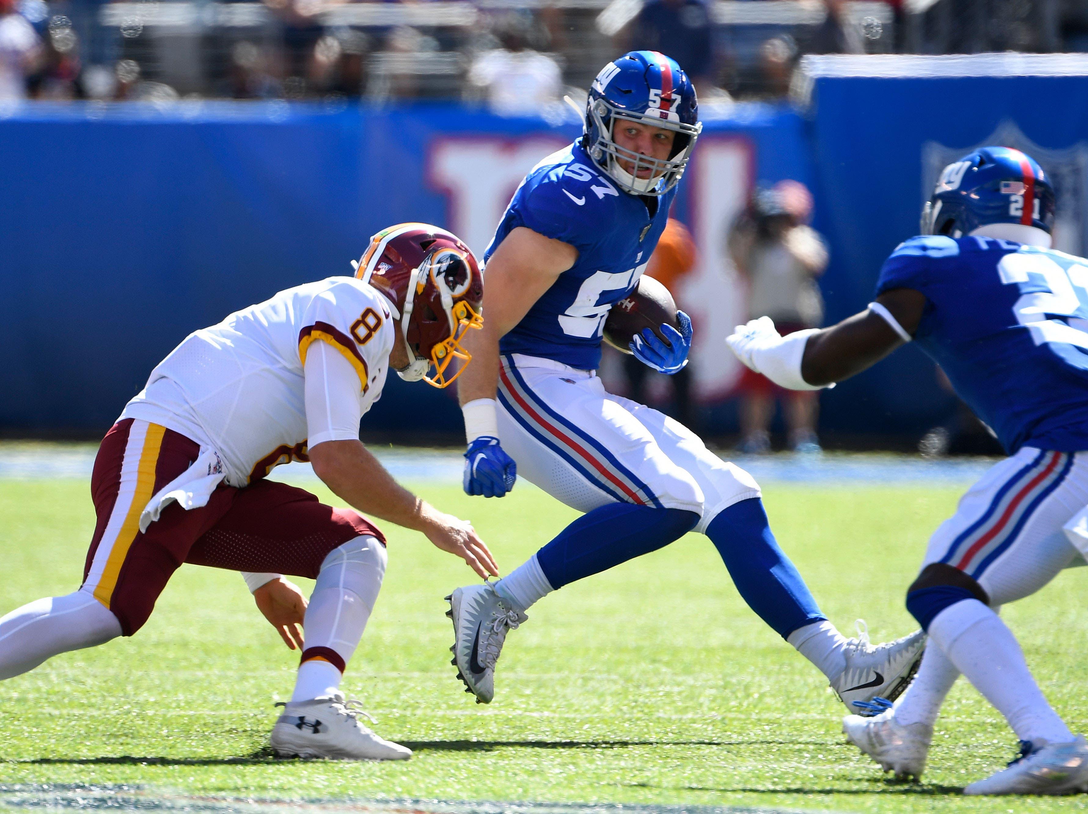 Sep 29, 2019; East Rutherford, NJ, USA; 
New York Giants inside linebacker Ryan Connelly (57) runs with the ball after intercepting a pass from Washington Redskins quarterback Case Keenum (not pictured) in the first quarter at MetLife Stadium. Mandatory Credit: Robert Deutsch-USA TODAY Sports / Robert Deutsch