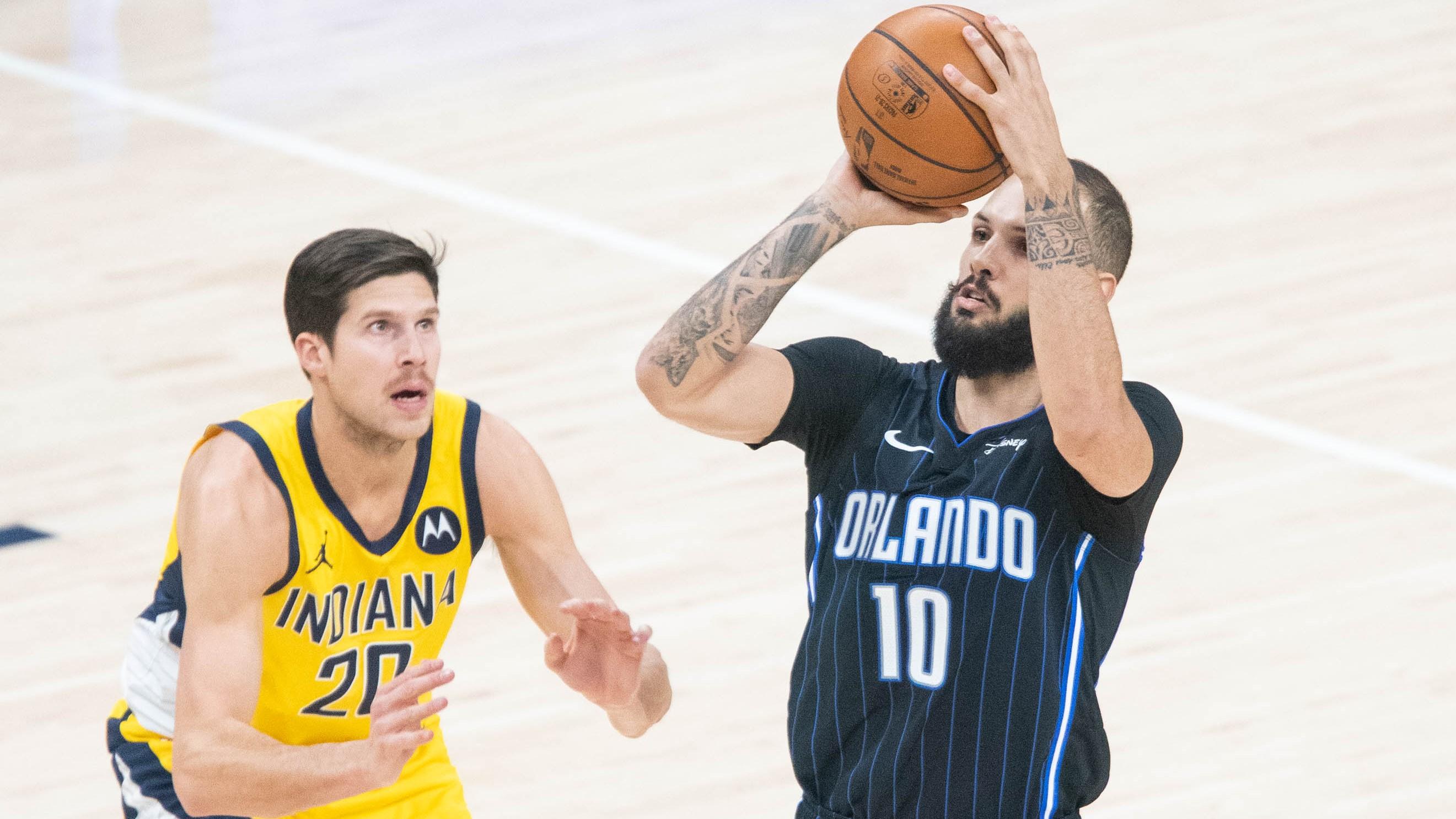 Jan 22, 2021; Indianapolis, Indiana, USA; Orlando Magic guard Evan Fournier (10) shoots the ball while Indiana Pacers forward Doug McDermott (20) defends in the second quarter at Bankers Life Fieldhouse. / Trevor Ruszkowski-USA TODAY Sports