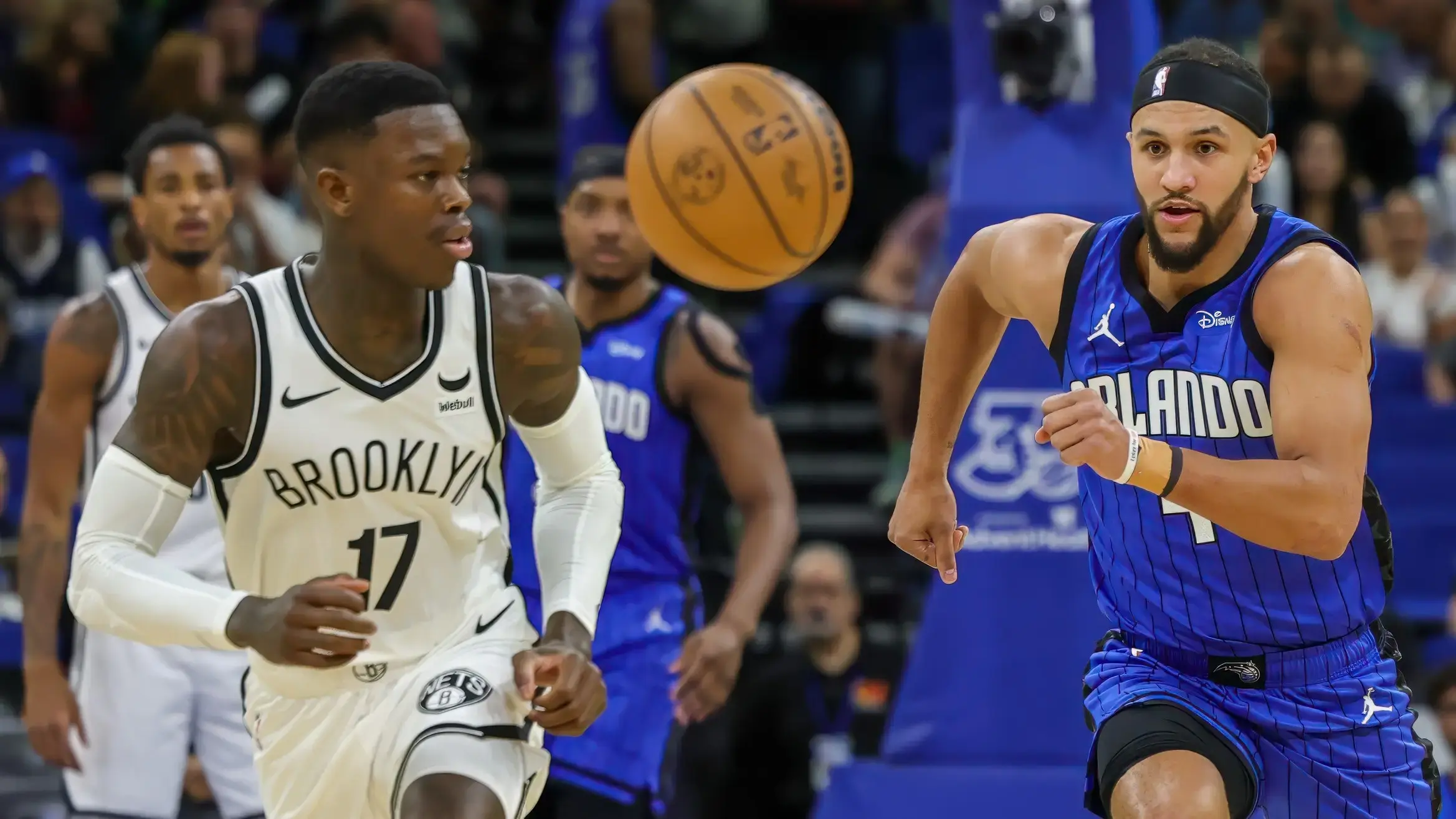 Orlando Magic guard Jalen Suggs (4) and Brooklyn Nets guard Dennis Schroder (17) chase a loose ball during the first quarter at Amway Center. / Mike Watters-USA TODAY Sports