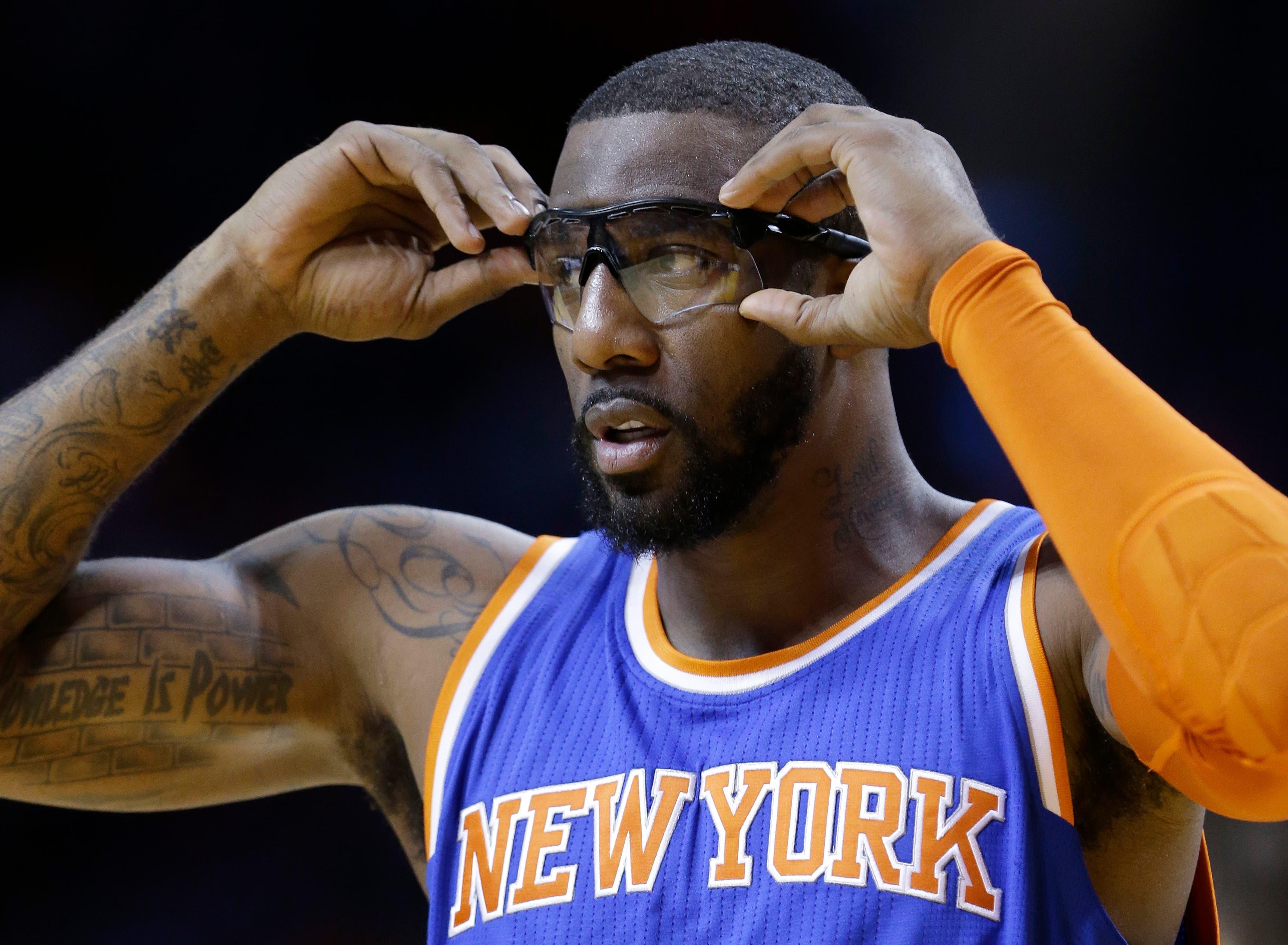 New York Knicks center Amar'e Stoudemire adjusts his glasses during the first half of an NBA basketball game against the Miami Heat, Monday, Feb. 9, 2015, in Miami. (AP Photo/Wilfredo Lee), / Wilfredo Lee/AP