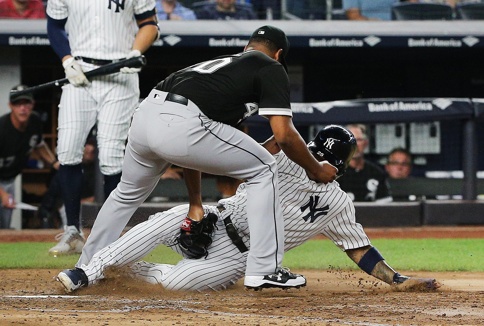 Aug 29, 2018; Bronx, NY, USA; Chicago White Sox starting pitcher Reynaldo Lopez (40) tags out shortstop Gleyber Torres (25) trying to score on a past ball during the fifth inning at Yankee Stadium. Mandatory Credit: Andy Marlin-USA TODAY Sports