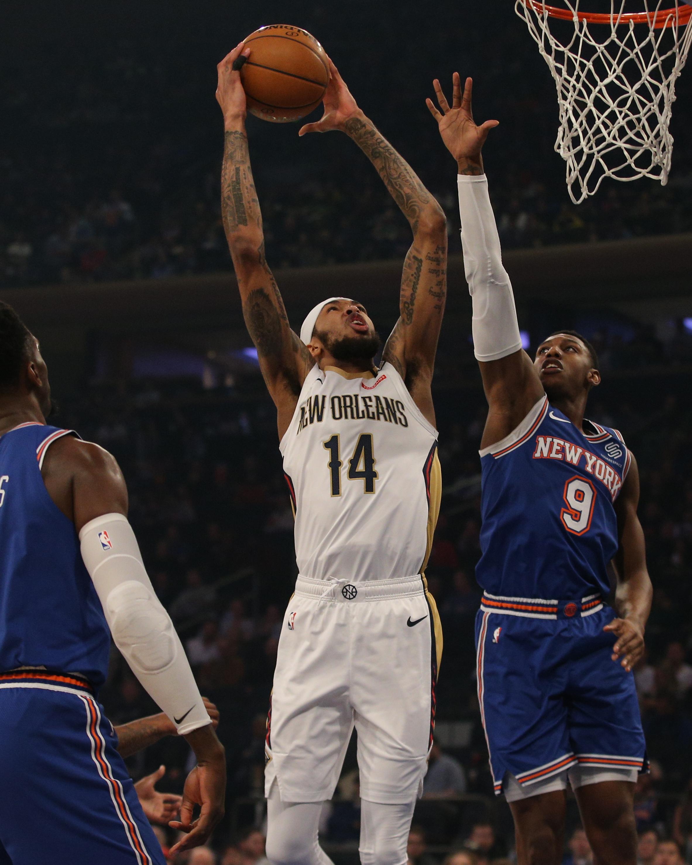 Jan 10, 2020; New York, New York, USA; New Orleans Pelicans small forward Brandon Ingram (14) drives to the basket against New York Knicks power forward Bobby Portis (1) and shooting guard RJ Barrett (9) during the first quarter at Madison Square Garden. Mandatory Credit: Brad Penner-USA TODAY Sports