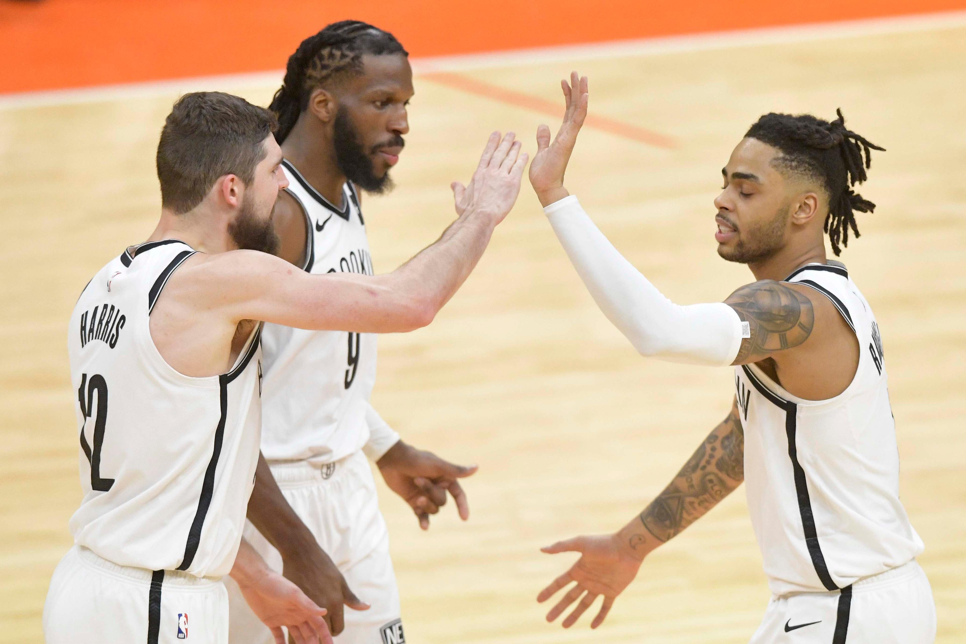 Feb 13, 2019; Cleveland, OH, USA; Brooklyn Nets guard D'Angelo Russell (1) celebrates with forward Joe Harris (12) snf forward DeMarre Carroll (9) in the third overtime against the Cleveland Cavaliers at Quicken Loans Arena. Mandatory Credit: David Richard-USA TODAY Sports / David Richard