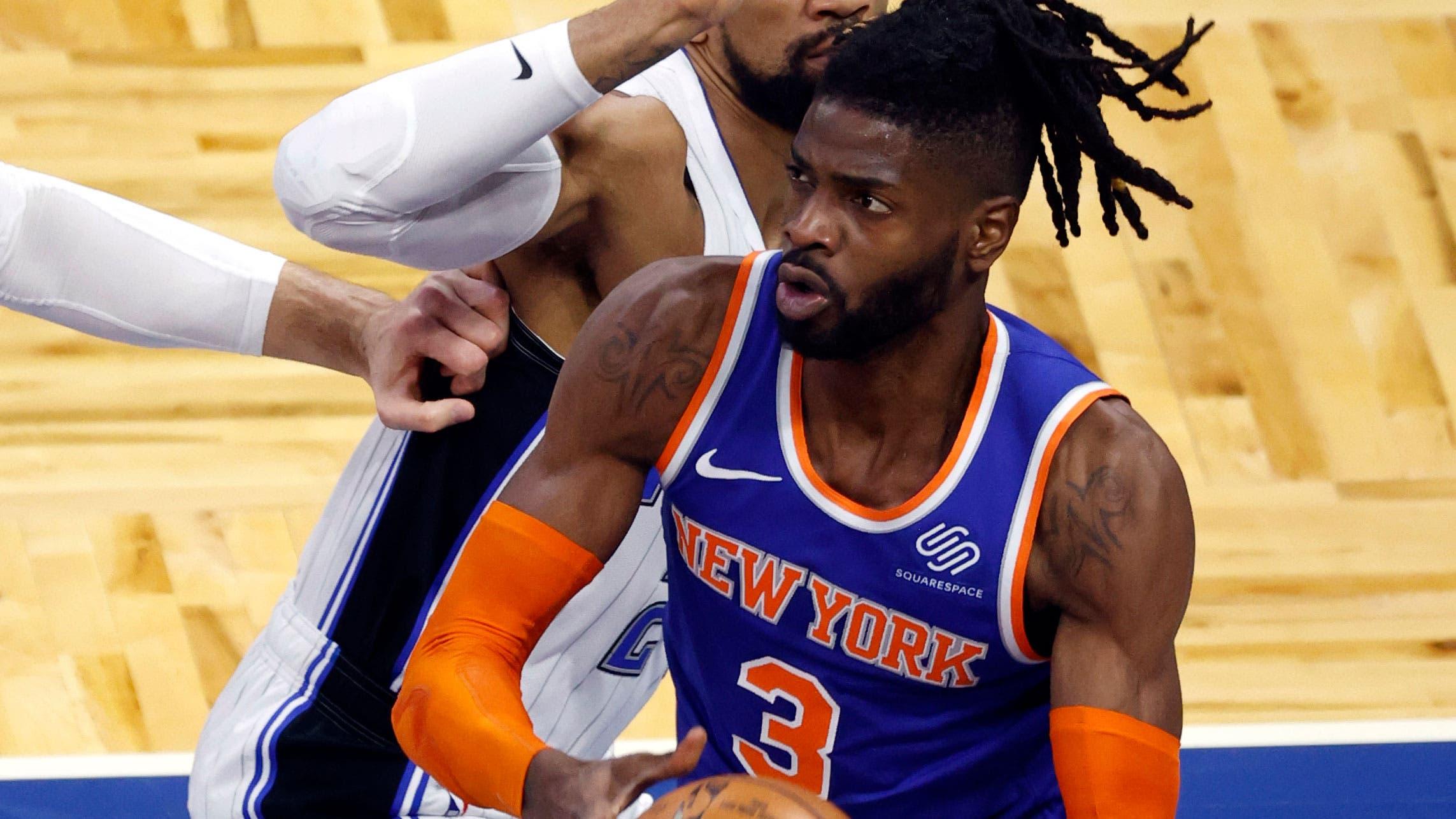 Feb 17, 2021; Orlando, Florida, USA; New York Knicks center Nerlens Noel (3) makes a basket over Orlando Magic center Khem Birch (24) during the first quarter at Amway Center. / Kim Klement-USA TODAY Sports