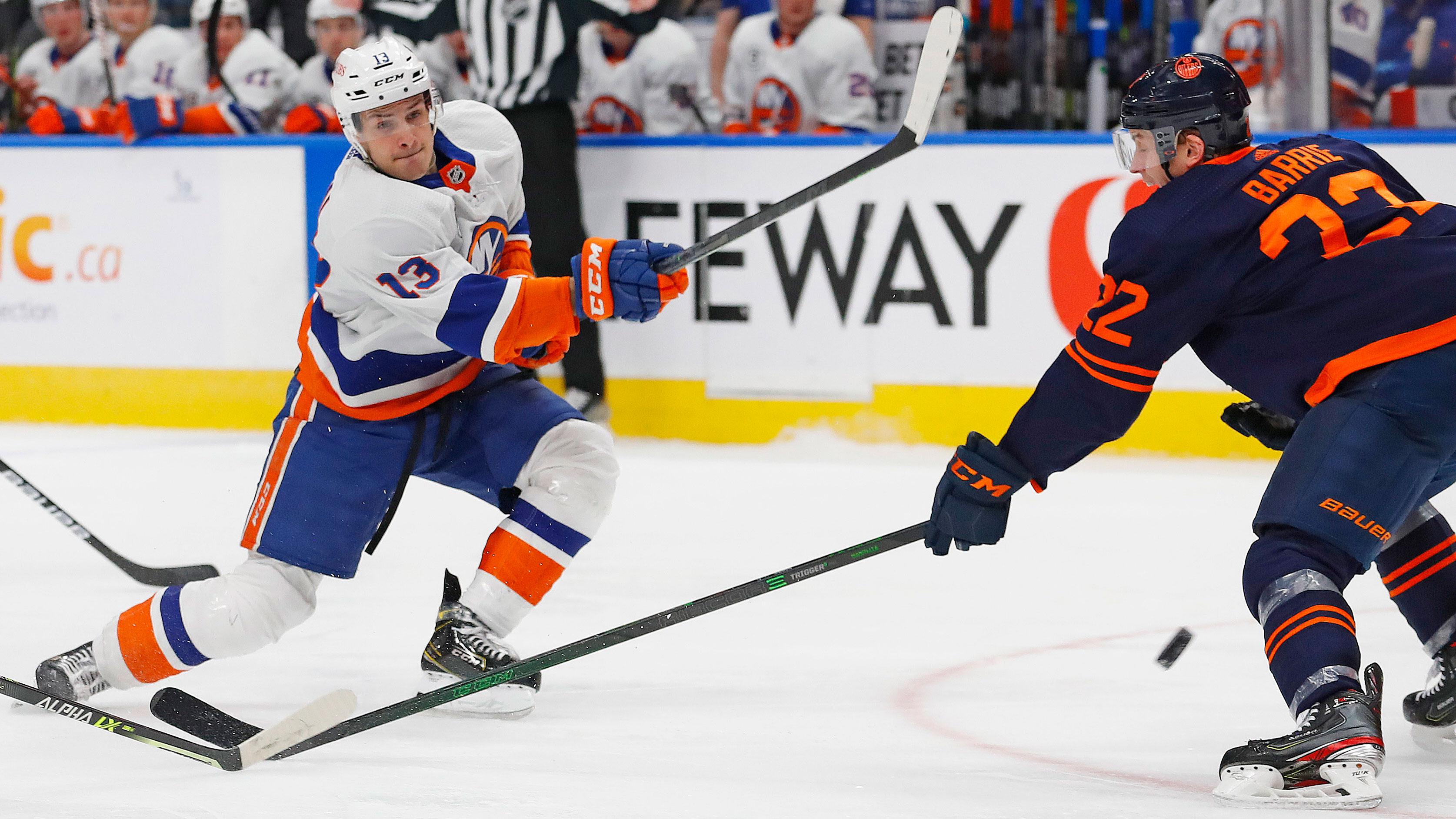 Feb 11, 2022; Edmonton, Alberta, CAN; New York Islanders forward Matt Barzal (13) takes a shot in front of Edmonton Oilers defensemen Tyson Barrie (22) during the second period at Rogers Place. / Perry Nelson-USA TODAY Sports