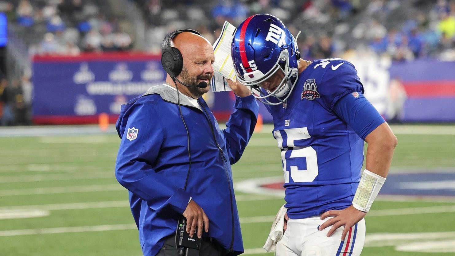  New York Giants quarterback Tommy DeVito (15) discusses the next play with New York Giants head coach Brian Daboll during the game against the Detroit Lions at MetLife Stadium. 