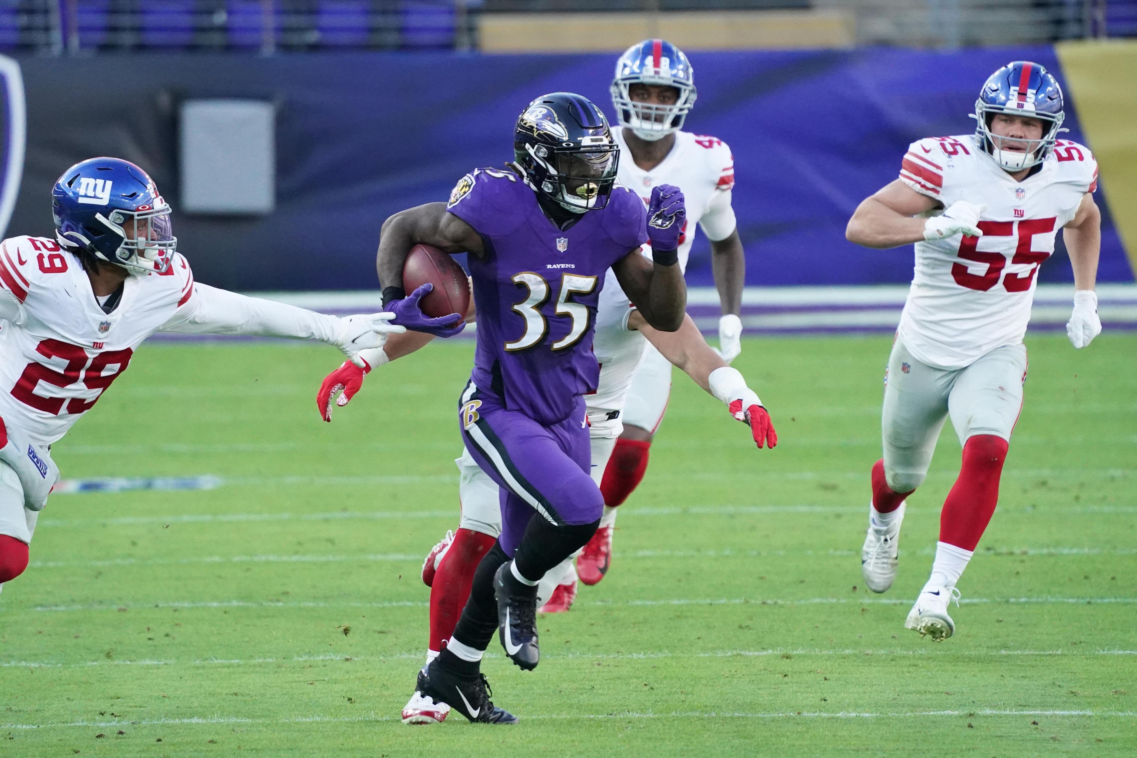Dec 27, 2020; Baltimore, Maryland, USA; Baltimore Ravens running back Gus Edwards (35) runs for a third quarter gain defended by New York Giants safety Xavier McKinney (29) at M&T Bank Stadium. / © Mitch Stringer-USA TODAY Sports