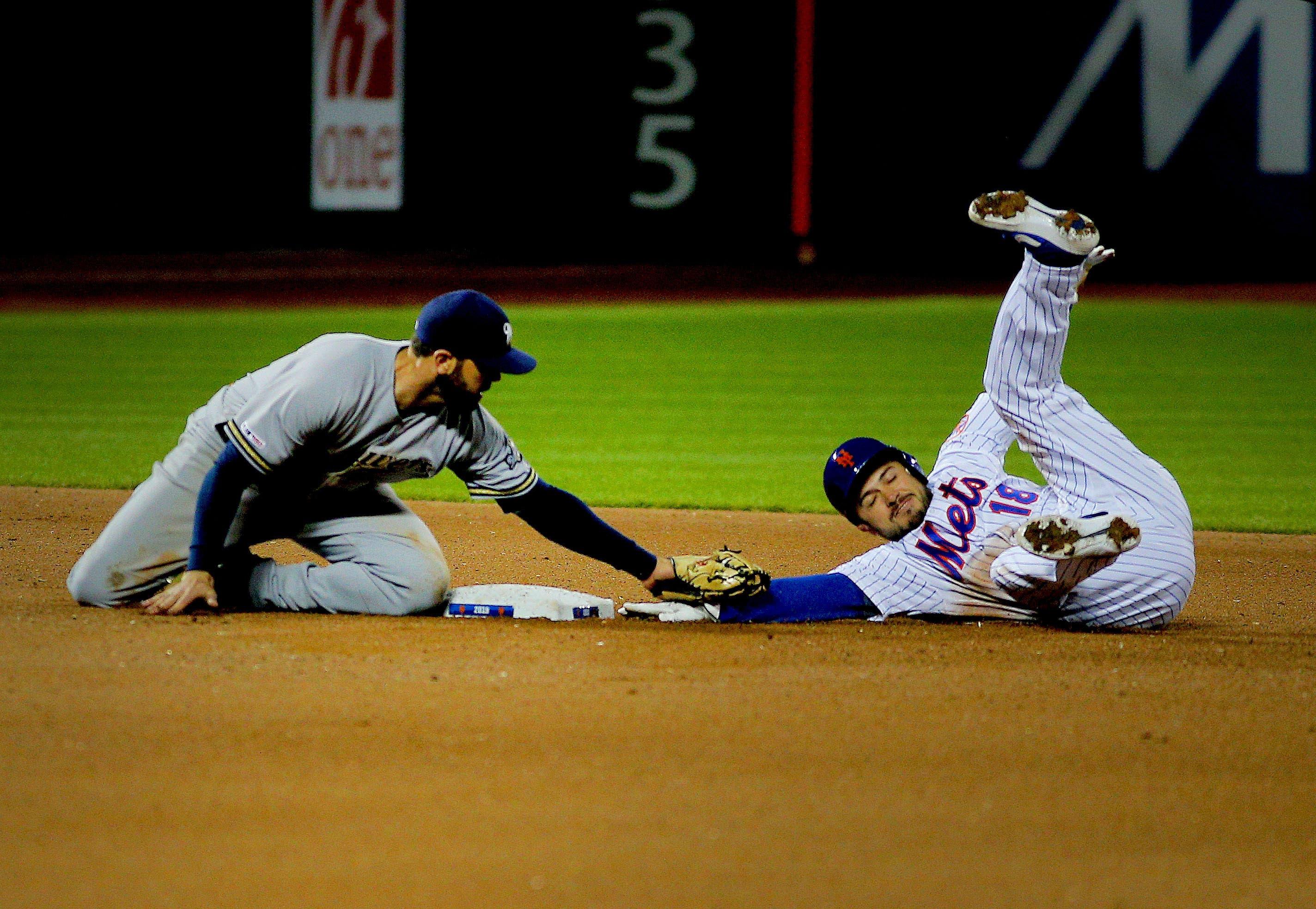 Apr 27, 2019; New York City, NY, USA; New York Mets catcher Travis d'Arnaud (18) is tagged out at second base by Milwaukee Brewers second baseman Mike Moustakas (11) trying to stretch a single into a double during the seventh inning at Citi Field. Mandatory Credit: Andy Marlin-USA TODAY Sports / Andy Marlin