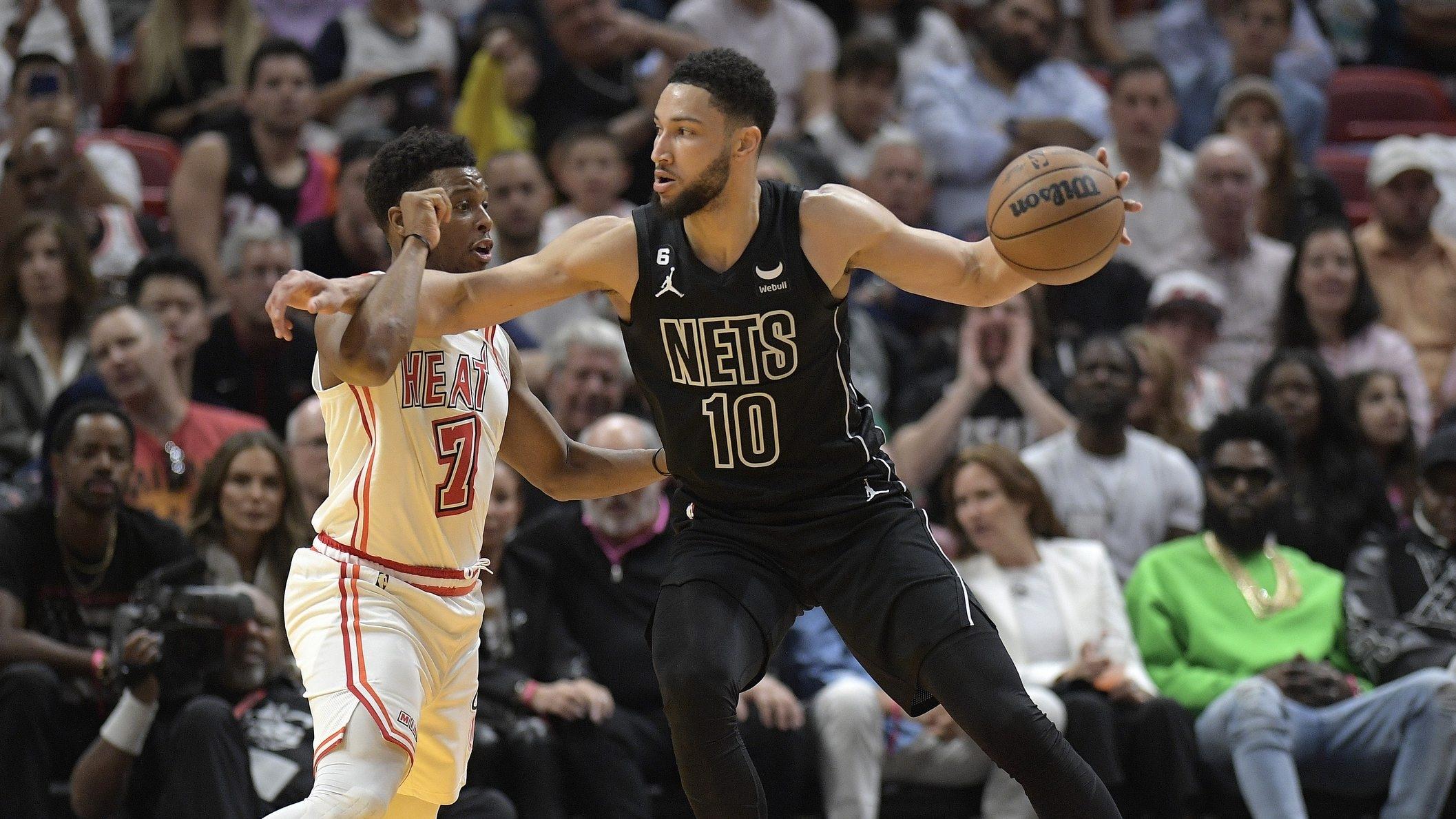 Brooklyn Nets guard Ben Simmons uses his arms to keep Miami Heat guard Kyle Lowry from the ball. / Michael Laughlin-USA TODAY Sports