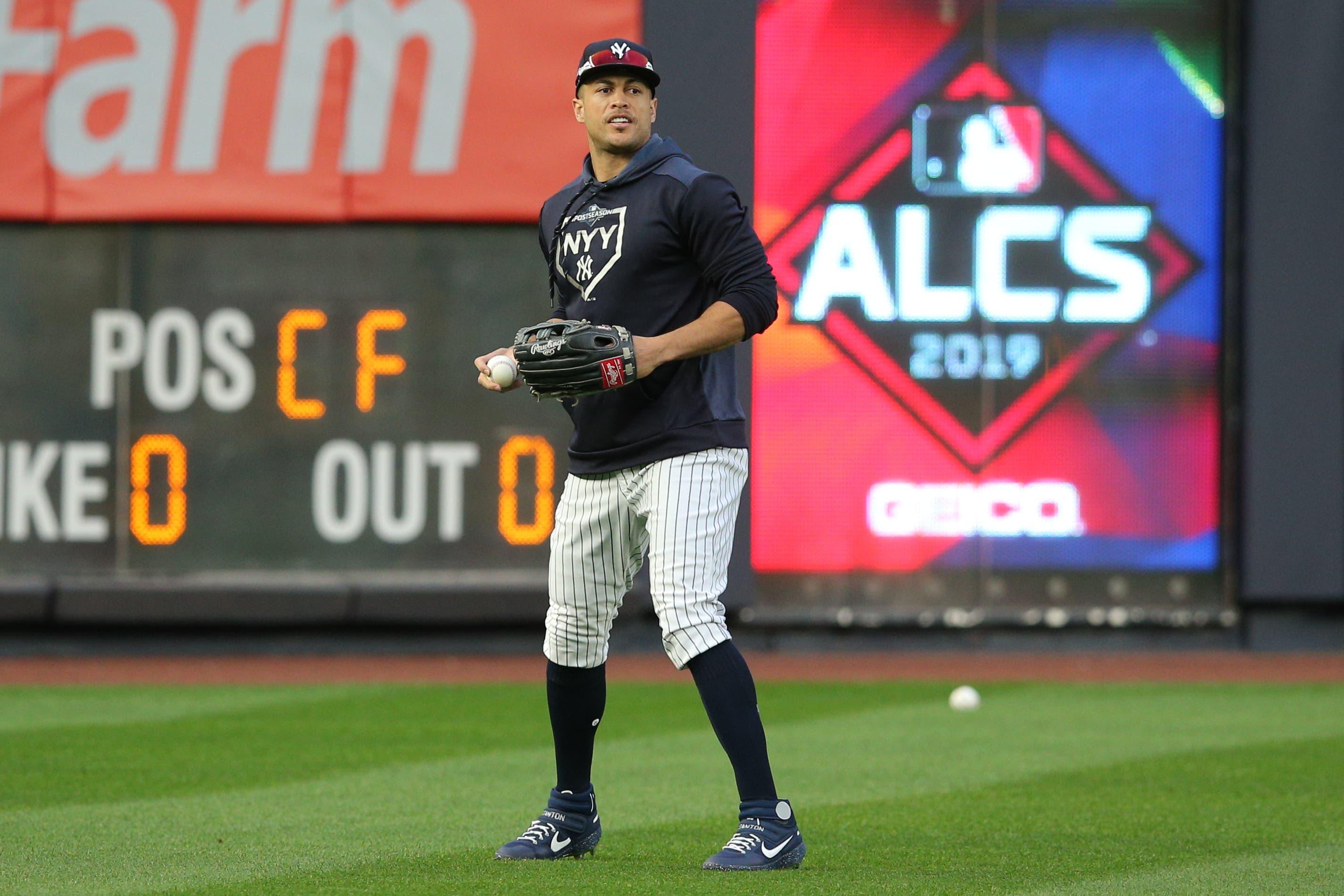 Oct 17, 2019; Bronx, NY, USA; New York Yankees left fielder Giancarlo Stanton (27) fields balls in the outfield during batting practice before game four of the 2019 ALCS playoff baseball series against the Houston Astros at Yankee Stadium. Mandatory Credit: Brad Penner-USA TODAY Sportsundefined