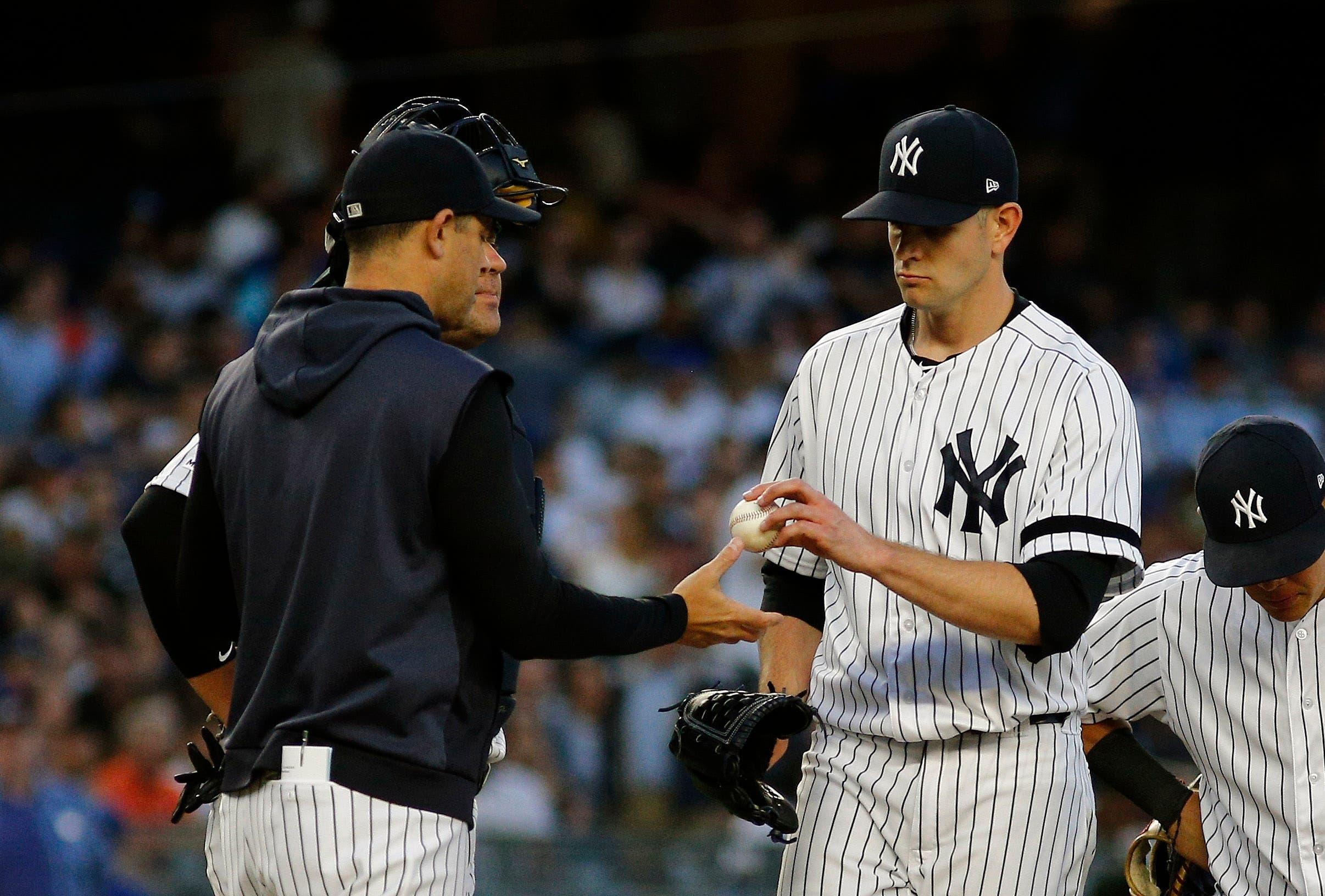 Jun 11, 2019; Bronx, NY, USA; New York Yankees starting pitcher James Paxton (65) hands the ball to manager Aaron Boone (17) after being taken out of the game against the New York Mets during the third inning of game two of a doubleheader at Yankee Stadium. Mandatory Credit: Andy Marlin-USA TODAY Sports / Andy Marlin