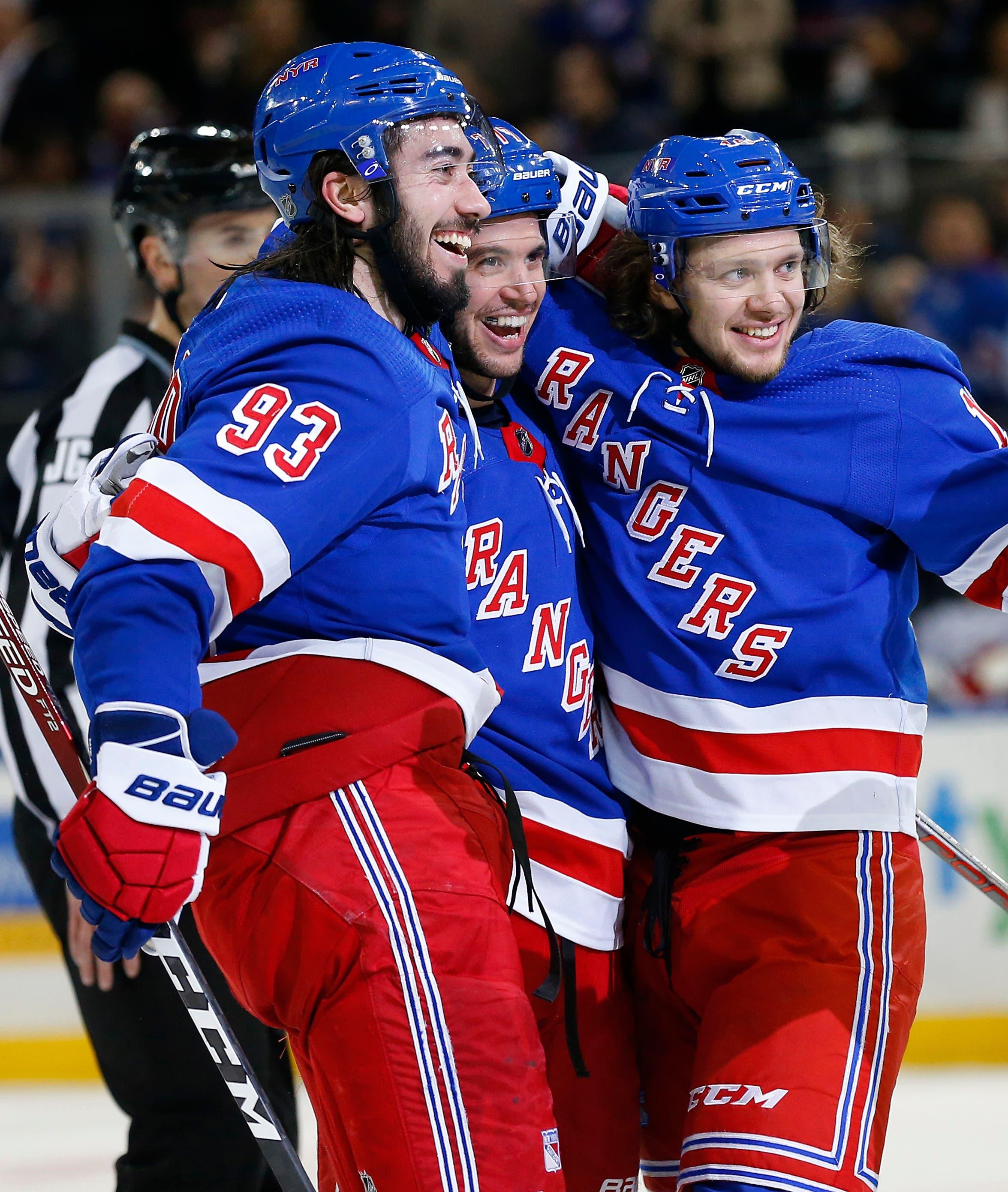 Jan 9, 2020; New York, New York, USA; New York Rangers defenseman Tony DeAngelo celebrates with teammates after a scoring a goal for a hat trick against the New Jersey Devils during the second period at Madison Square Garden. Mandatory Credit: Noah K. Murray-USA TODAY Sports / Noah K. Murray