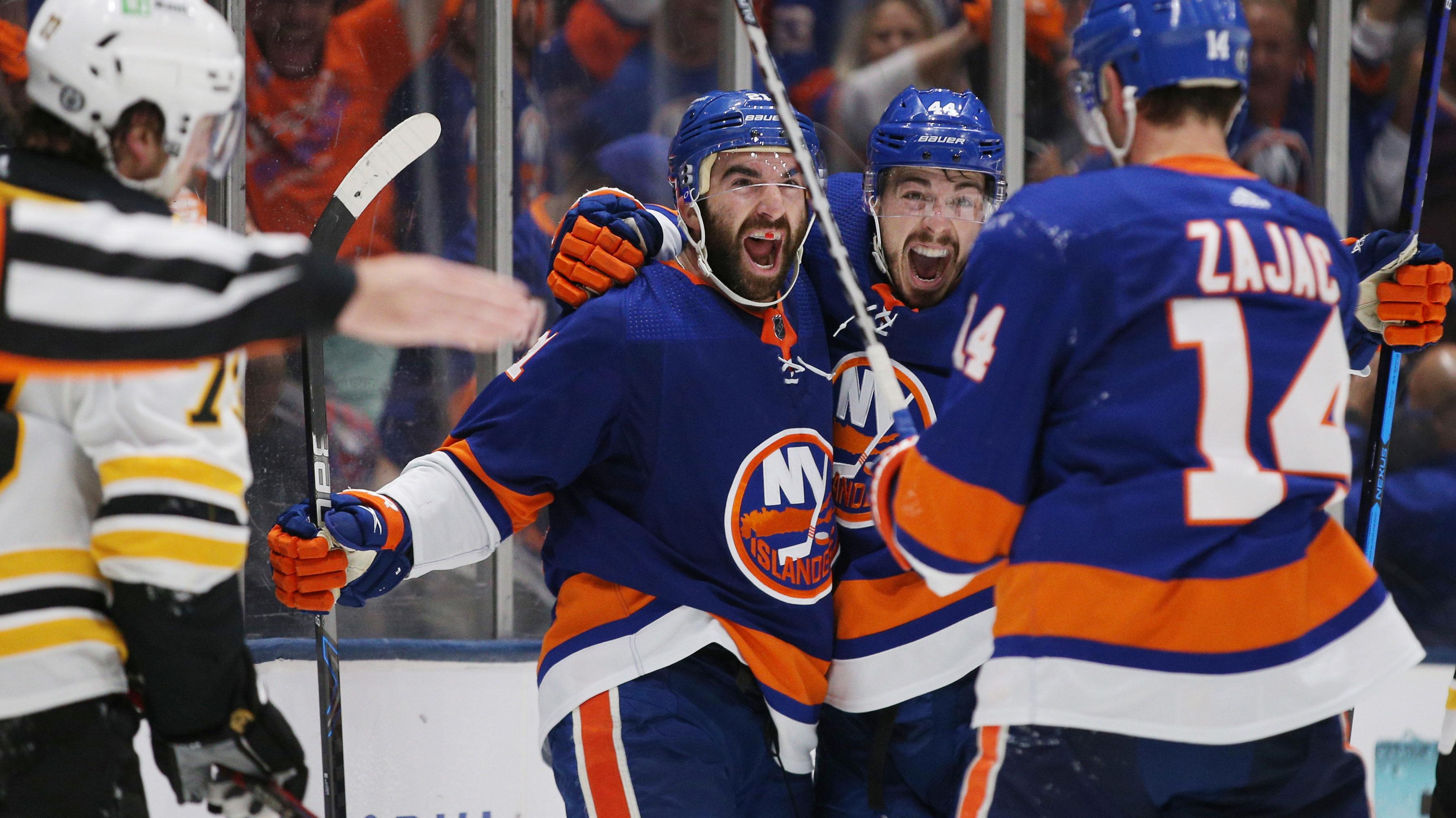 Jun 9, 2021; Uniondale, New York, USA; New York Islanders right wing Kyle Palmieri (21) celebrates his goal against the Boston Bruins with center Jean-Gabriel Pageau (44) and center Travis Zajac (14) during the second period of game six of the second round of the 2021 Stanley Cup Playoffs at Nassau Veterans Memorial Coliseum. / Brad Penner-USA TODAY Sports