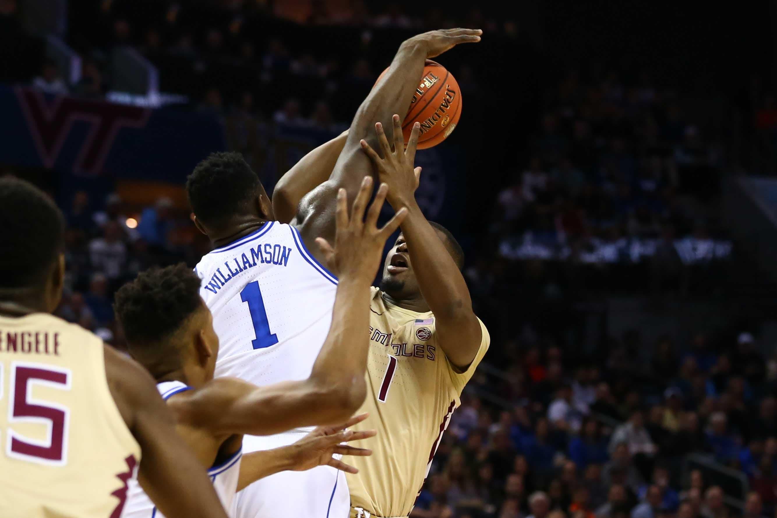 Mar 16, 2019; Charlotte, NC, USA; Duke Blue Devils forward Zion Williamson (1) blocks the shot of Florida State Seminoles forward Raiquan Gray (1) in the first half in the ACC conference tournament at Spectrum Center. Mandatory Credit: Jeremy Brevard-USA TODAY Sports / Jeremy Brevard