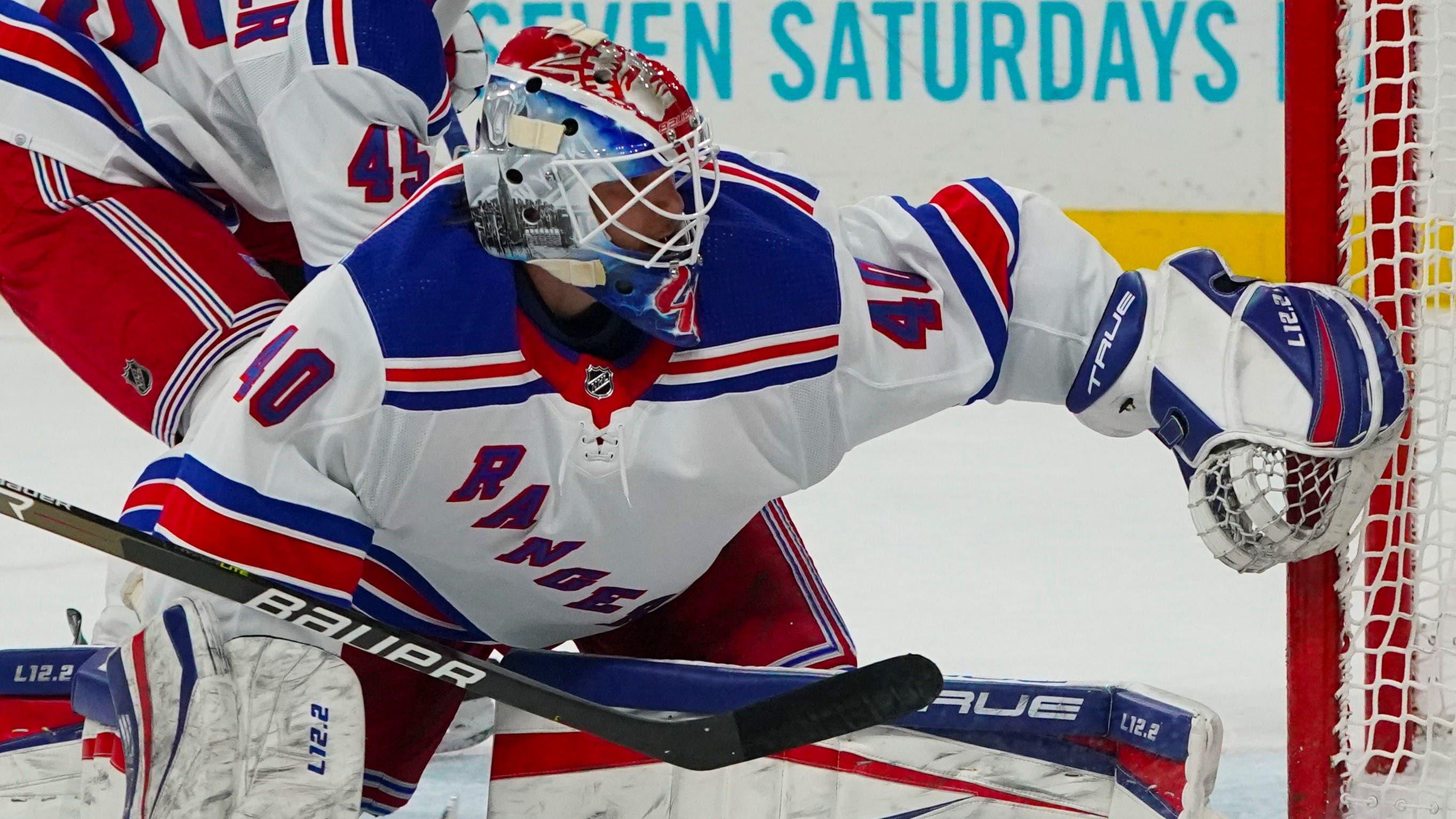 Mar 20, 2022; Raleigh, North Carolina, USA; New York Rangers goaltender Alexandar Georgiev (40) and defenseman Braden Schneider (45) watch the puck during the first period at PNC Arena. Mandatory Credit: James Guillory-USA TODAY Sports / James Guillory-USA TODAY Sports