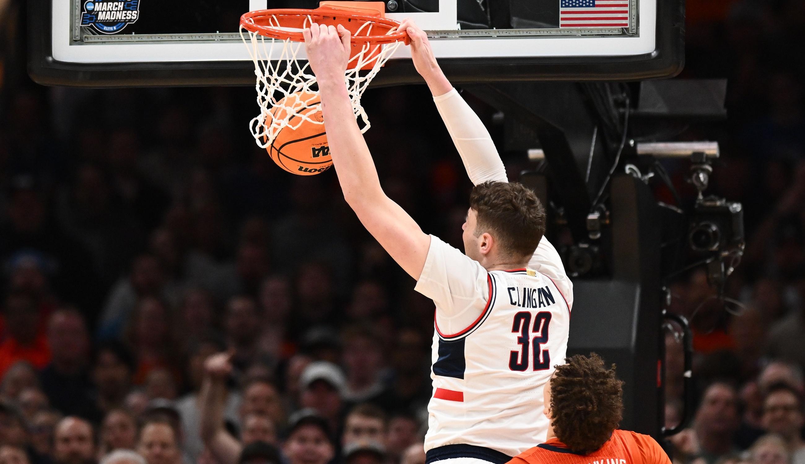 Connecticut Huskies center Donovan Clingan (32) dunks the ball against Illinois Fighting Illini forward Coleman Hawkins (33) in the finals of the East Regional of the 2024 NCAA Tournament at TD Garden. / Brian Fluharty-USA TODAY Sports
