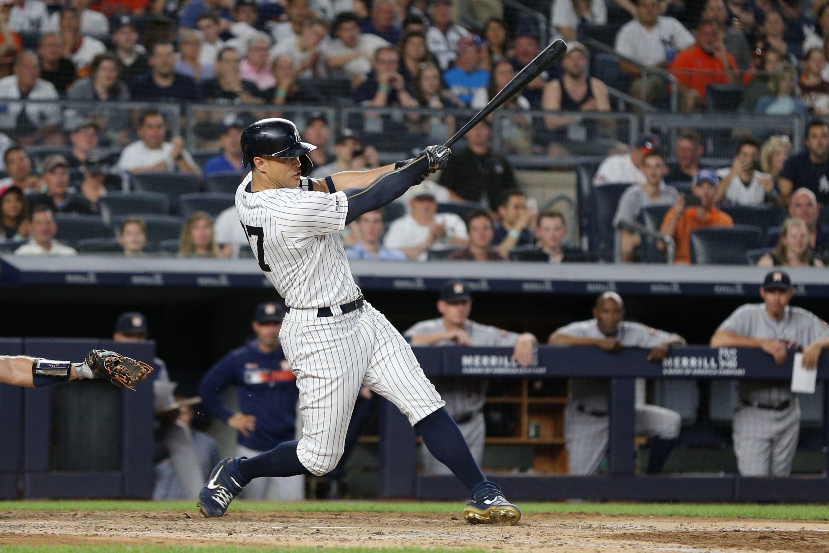 Jun 22, 2019; Bronx, NY, USA; New York Yankees left fielder Giancarlo Stanton (27) follows through on a two run infield single against the Houston Astros during the sixth inning at Yankee Stadium. Mandatory Credit: Brad Penner-USA TODAY Sports / Brad Penner