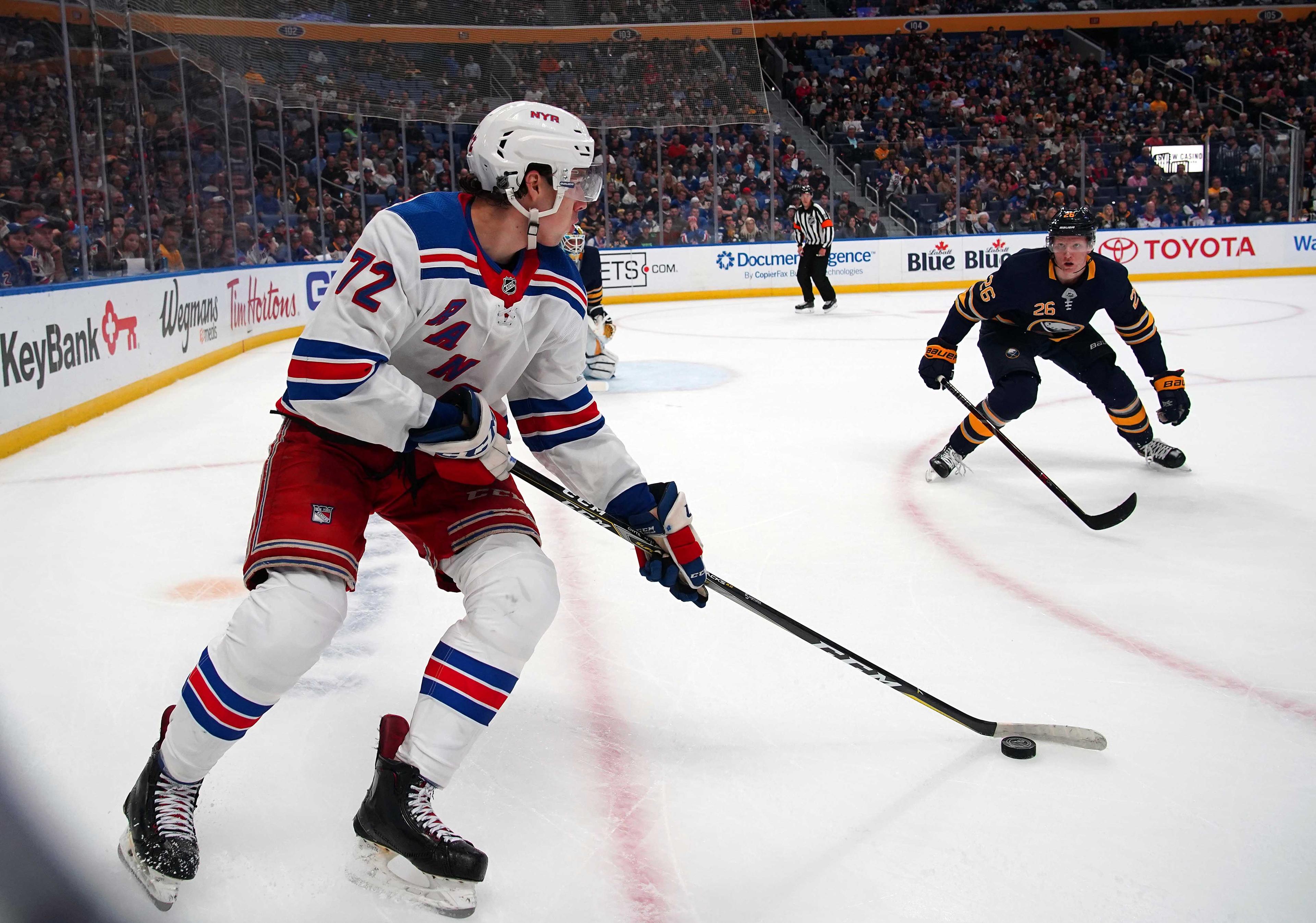 Oct 6, 2018; Buffalo, NY, USA; Buffalo Sabres defenseman Rasmus Dahlin (26) defends as New York Rangers center Filip Chytil (72) moves the puck during the first period at KeyBank Center. Mandatory Credit: Kevin Hoffman-USA TODAY Sports / Kevin Hoffman