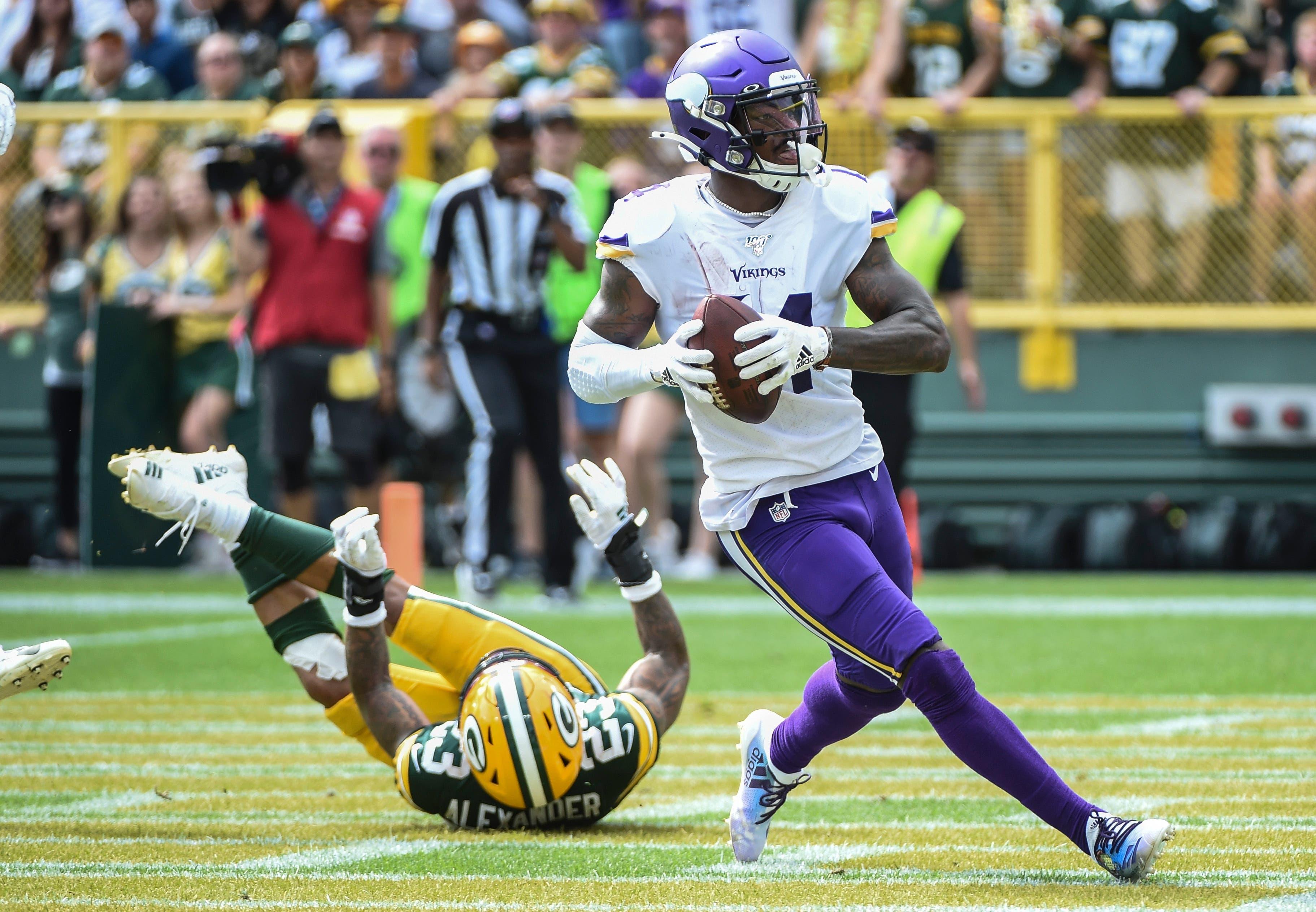 Sep 15, 2019; Green Bay, WI, USA; Minnesota Vikings wide receiver Stefon Diggs (14) catches a pass against Green Bay Packers cornerback Jaire Alexander (23) for a touchdown in the third quarter at Lambeau Field. Mandatory Credit: Benny Sieu-USA TODAY Sportsundefined