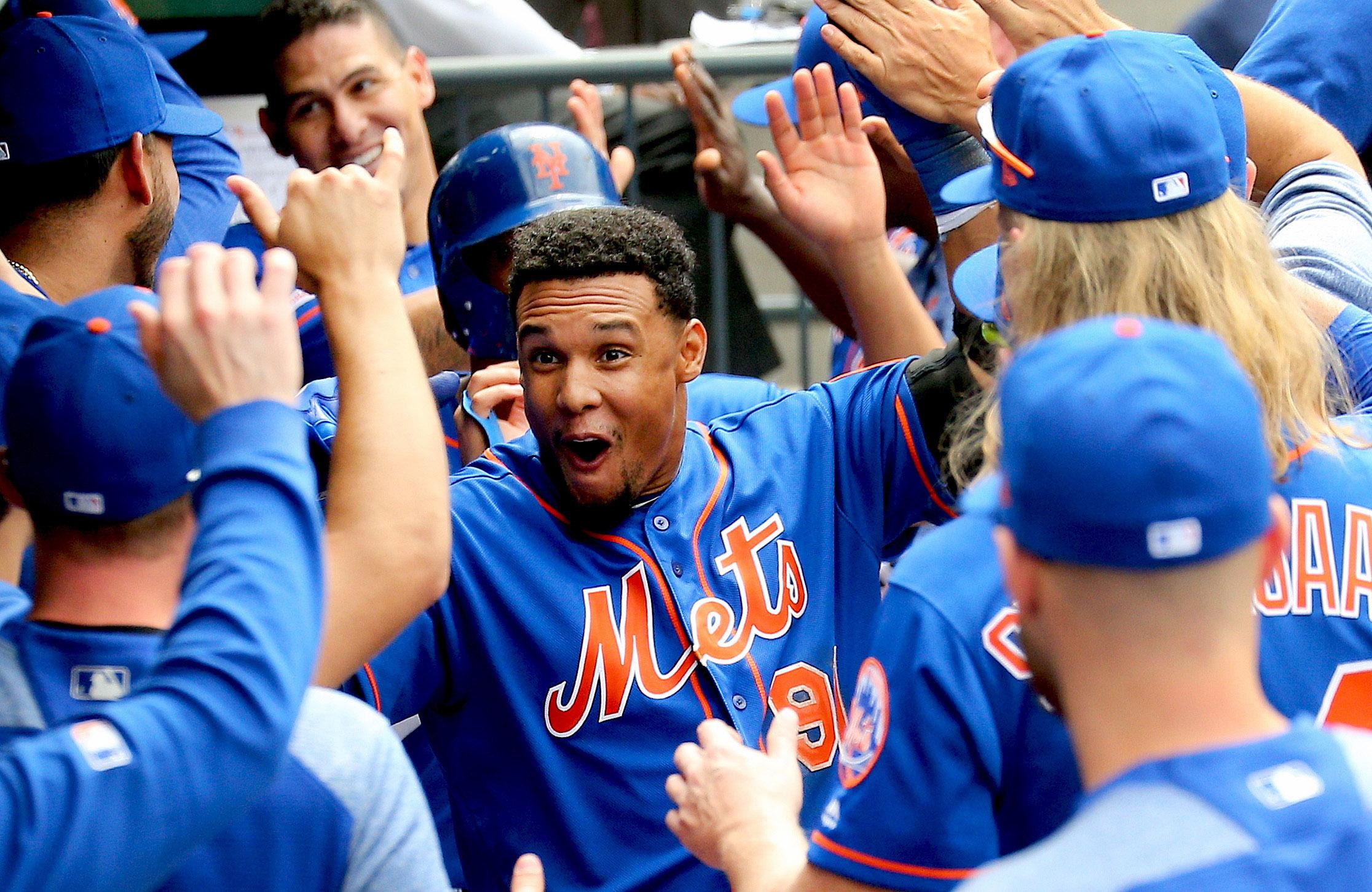 May 23, 2019; New York City, NY, USA; New York Mets right fielder Carlos Gomez (91) is congratulated in the dugout after hitting a three run home run against the Washington Nationals during the eighth inning at Citi Field. Mandatory Credit: Andy Marlin-USA TODAY Sports