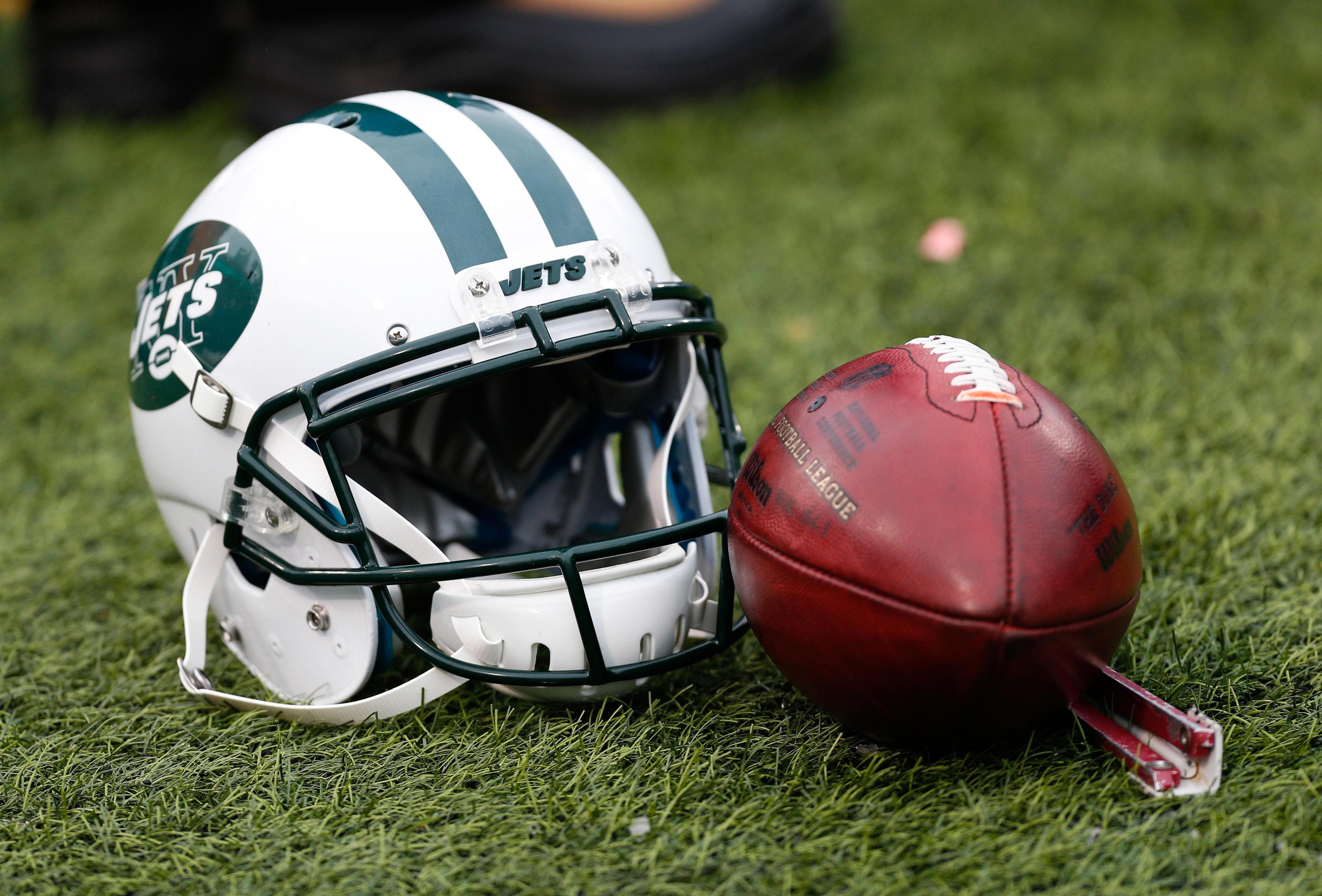 A general view of a New York Jets helmet and an NFL football during the game between the Buffalo Bills and the New York Jets at Ralph Wilson Stadium. / Kevin Hoffman