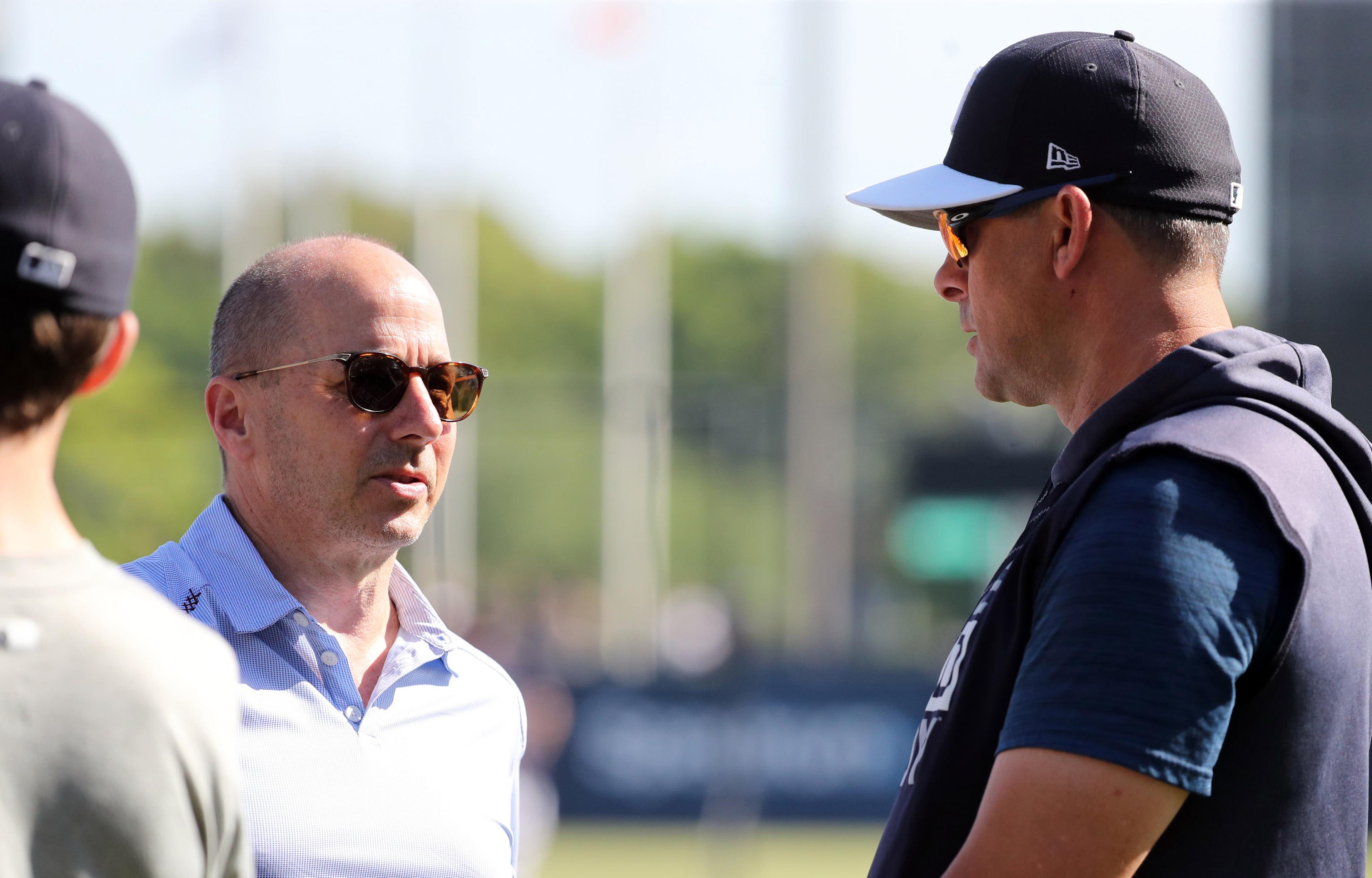 Mar 15, 2019; Tampa, FL, USA; New York Yankees general manager Brian Cashman and manager Aaron Boone (17) talk prior to the game against the Boston Red Sox at George M. Steinbrenner Field. Mandatory Credit: Kim Klement-USA TODAY Sports / Kim Klement