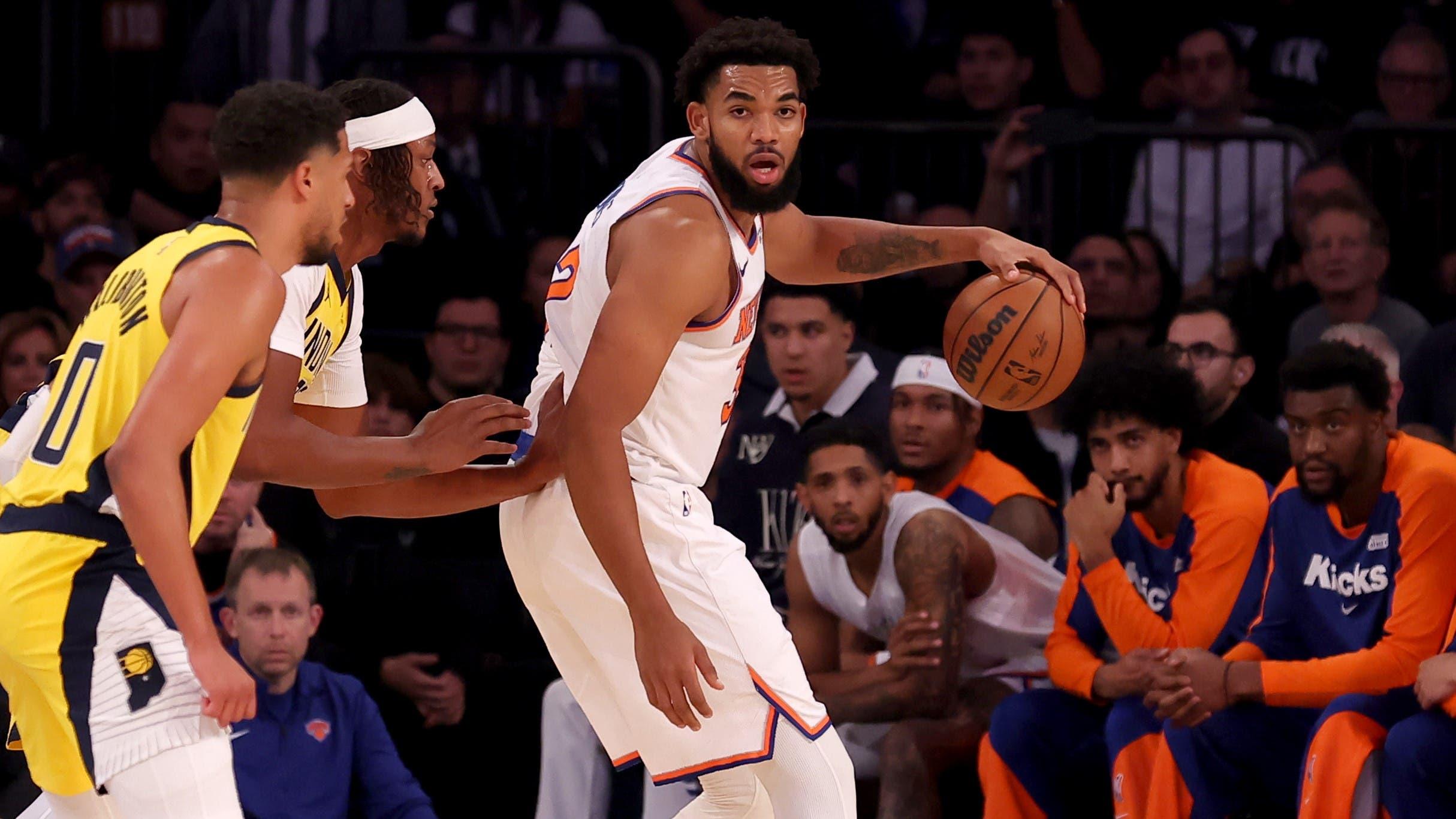 Oct 25, 2024; New York, New York, USA; New York Knicks center Karl-Anthony Towns (32) controls the ball against Indiana Pacers center Myles Turner (33) and guard Tyrese Haliburton (0) during the first quarter at Madison Square Garden. Mandatory Credit: Brad Penner-Imagn Images