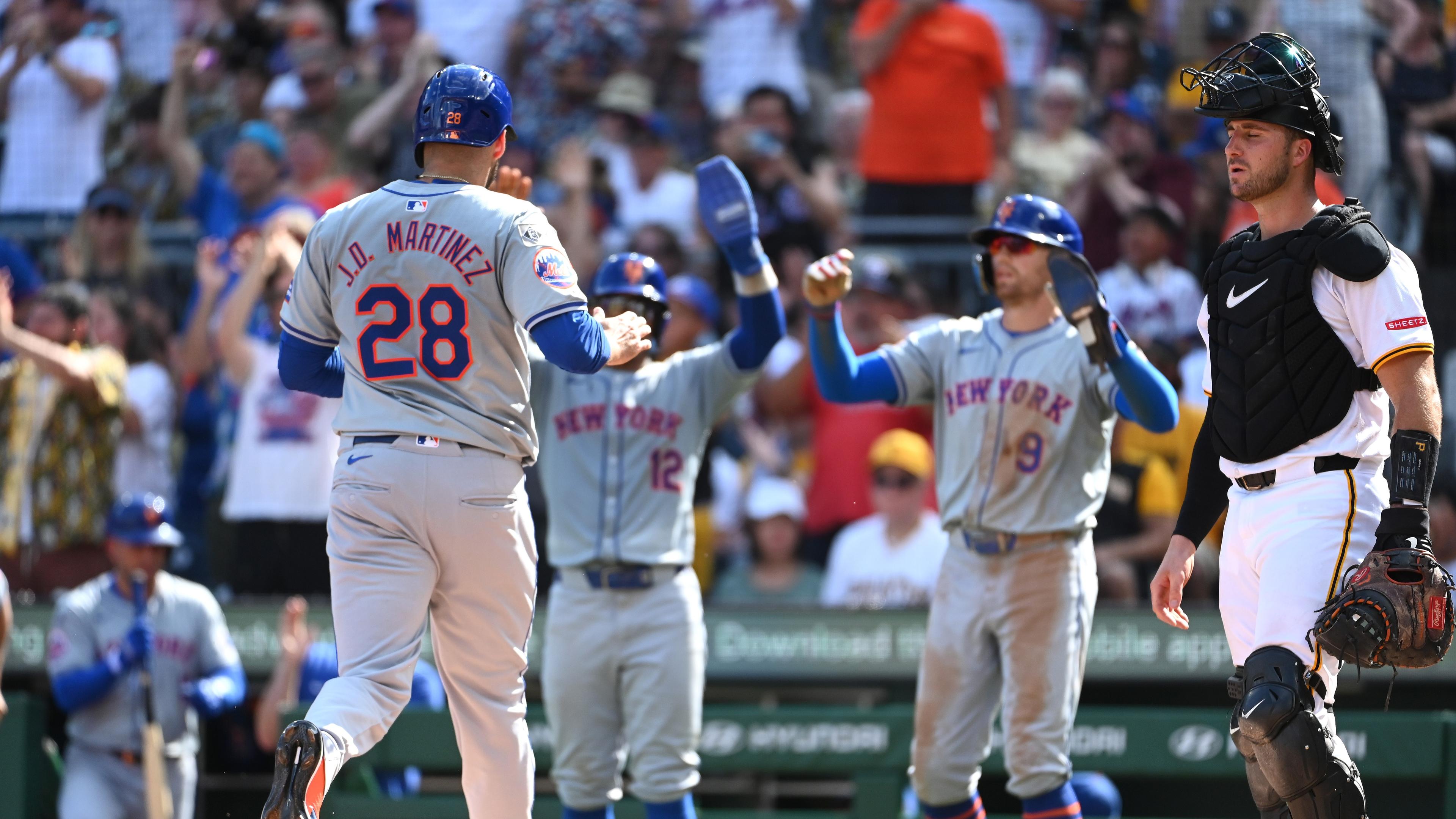 Jul 6, 2024; Pittsburgh, Pennsylvania, USA; New York Mets base runner J.D. Martinez (28) scores by Pittsburgh Pirates catcher Joey Bart (14) befote being greeted by Francisco Lindor (12) and Brandon Nimmo (9) during the third inning at PNC Park. Mandatory Credit: Philip G. Pavely-USA TODAY Sports