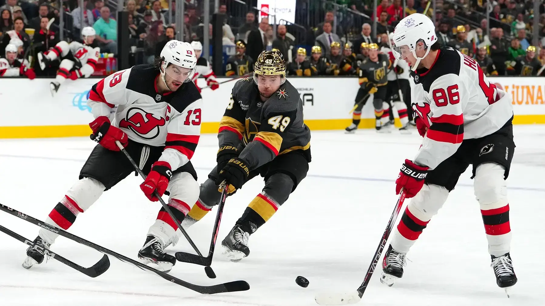 Vegas Golden Knights center Ivan Barbashev (49) misses a pass from New Jersey Devils center Nico Hischier (13) to New Jersey Devils center Jack Hughes (86) during the second period at T-Mobile Arena. / Stephen R. Sylvanie-USA TODAY Sports
