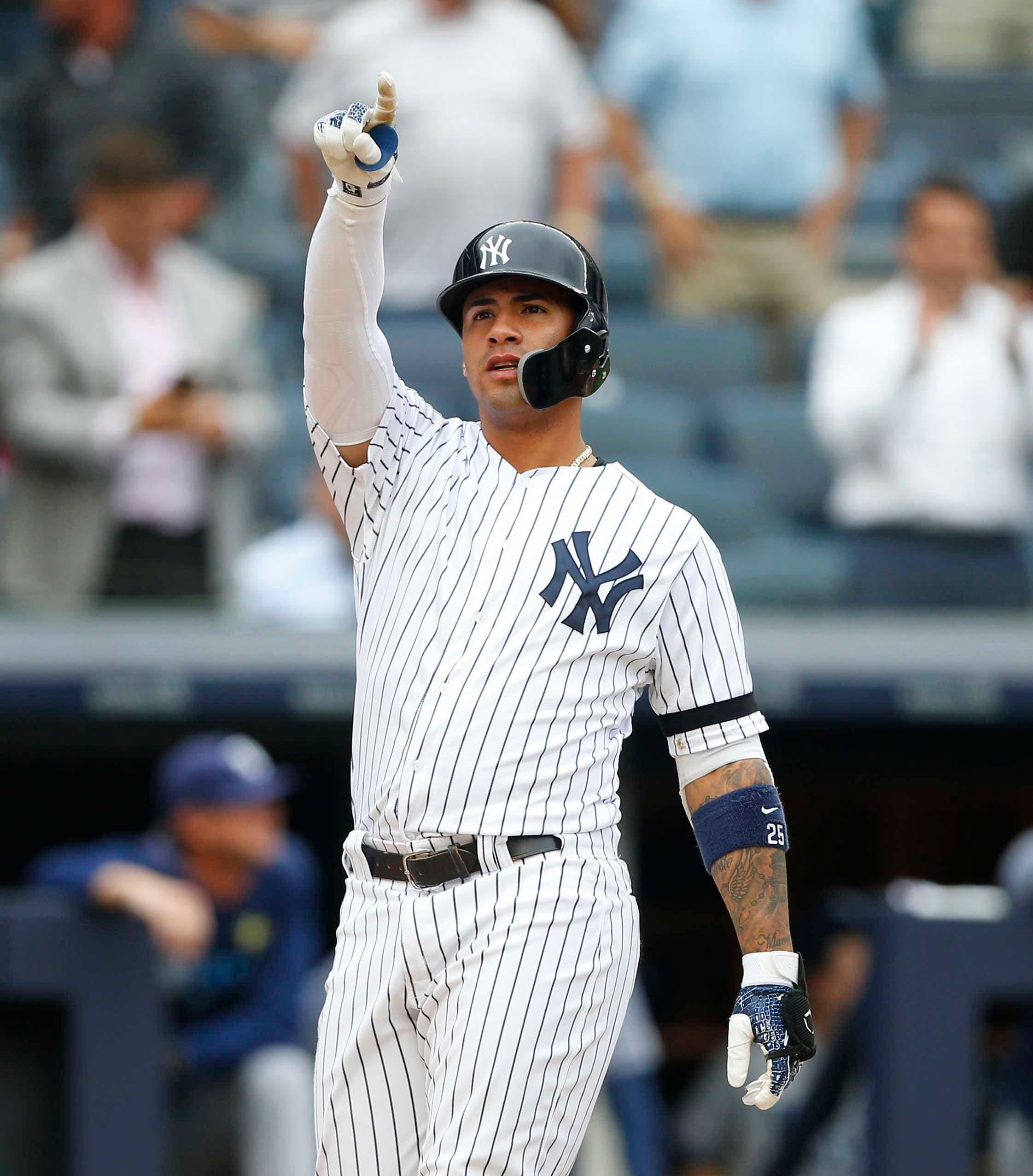 New York Yankees second baseman Gleyber Torres reacts at home plate after hitting a grand slam in the seventh inning against the Tampa Bay Rays at Yankee Stadium. / Noah K. Murray/USA TODAY Sports