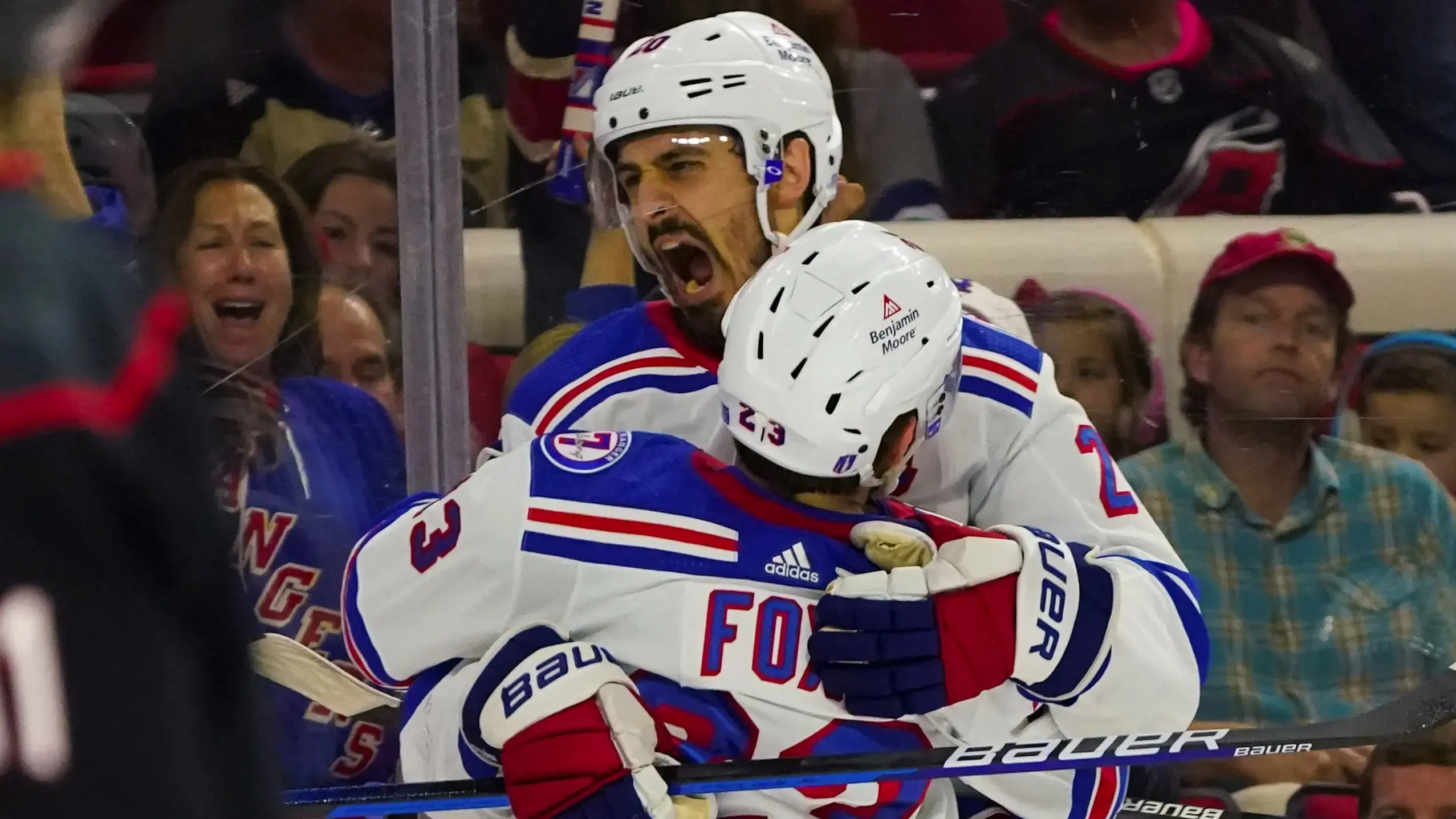 May 30, 2022; Raleigh, North Carolina, USA; New York Rangers left wing Chris Kreider (20) is congratulated by defenseman Adam Fox (23) after his goal against the Carolina Hurricanes during the third period in game seven of the second round of the 2022 Stanley Cup Playoffs at PNC Arena. Mandatory Credit: James Guillory-USA TODAY Sports / James Guillory-USA TODAY Sports