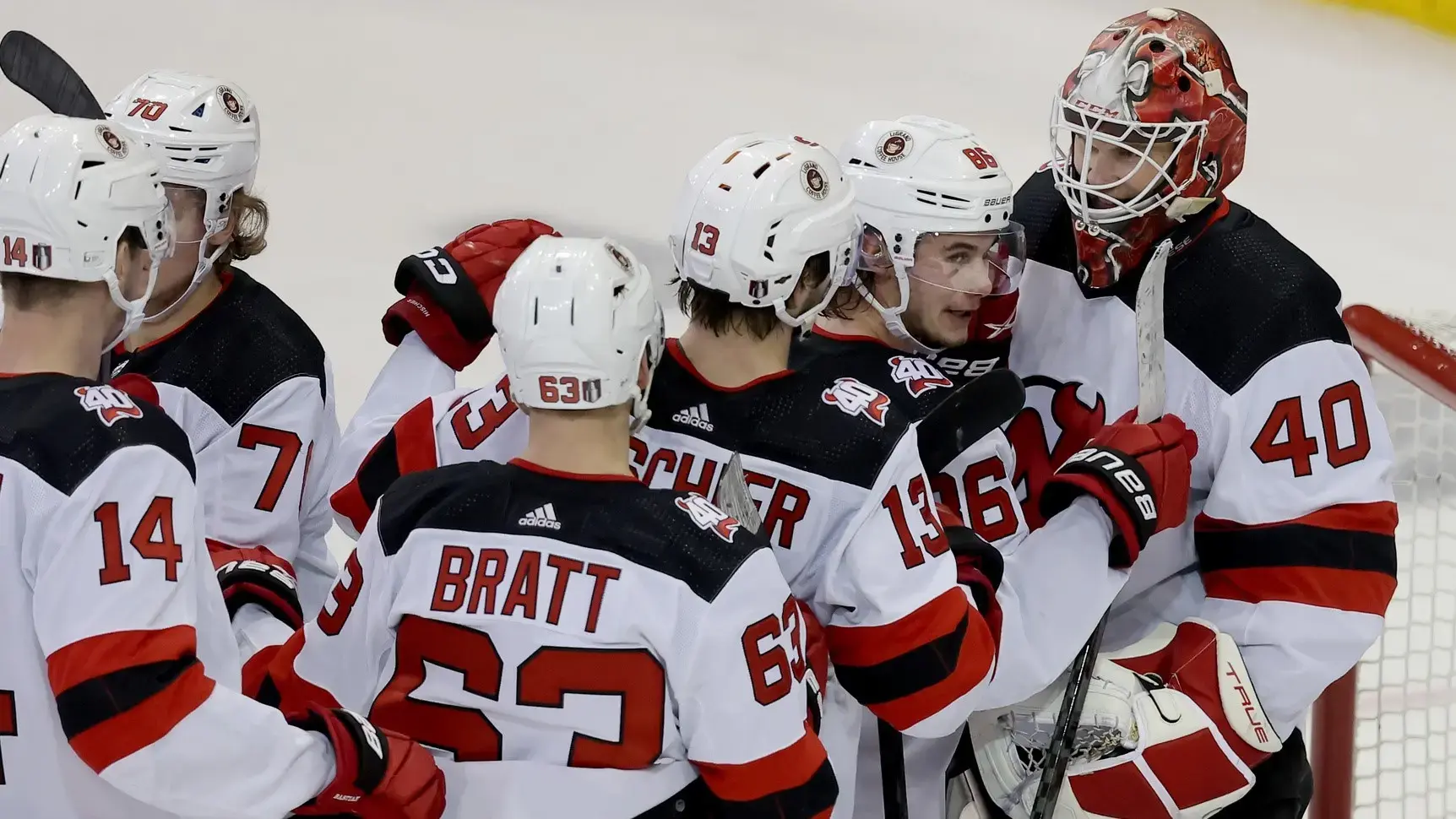 Apr 24, 2023; New York, New York, USA; New Jersey Devils goaltender Akira Schmid (40) celebrates with center Jack Hughes (86) and center Nico Hischier (13) after defeating the New York Rangers in game four of the first round of the 2023 Stanley Cup Playoffs at Madison Square Garden / Brad Penner-USA TODAY Sports