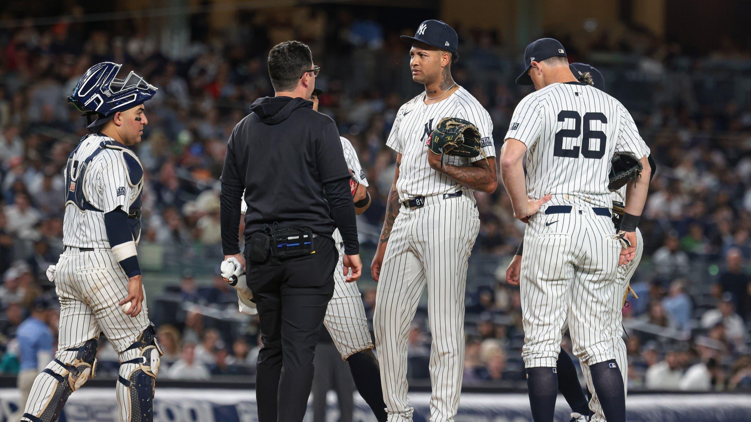 Aug 20, 2024; Bronx, New York, USA; New York Yankees starting pitcher Luis Gil (81) talks with a member of the medical staff before being relieved during the fourth inning against the Cleveland Guardians at Yankee Stadium. / Vincent Carchietta-USA TODAY Sports