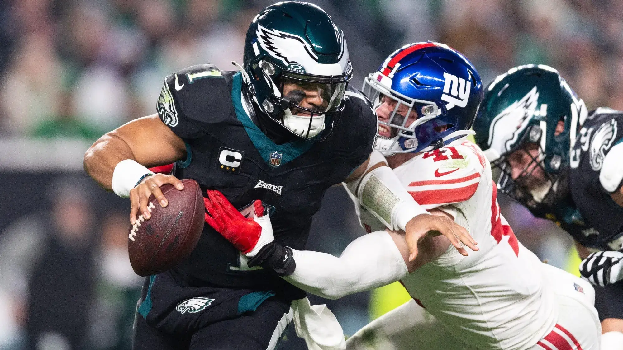 Philadelphia Eagles quarterback Jalen Hurts (1) eludes the tackle attempt of New York Giants linebacker Micah McFadden (41) during the second quarter at Lincoln Financial Field. / Bill Streicher-USA TODAY Sports