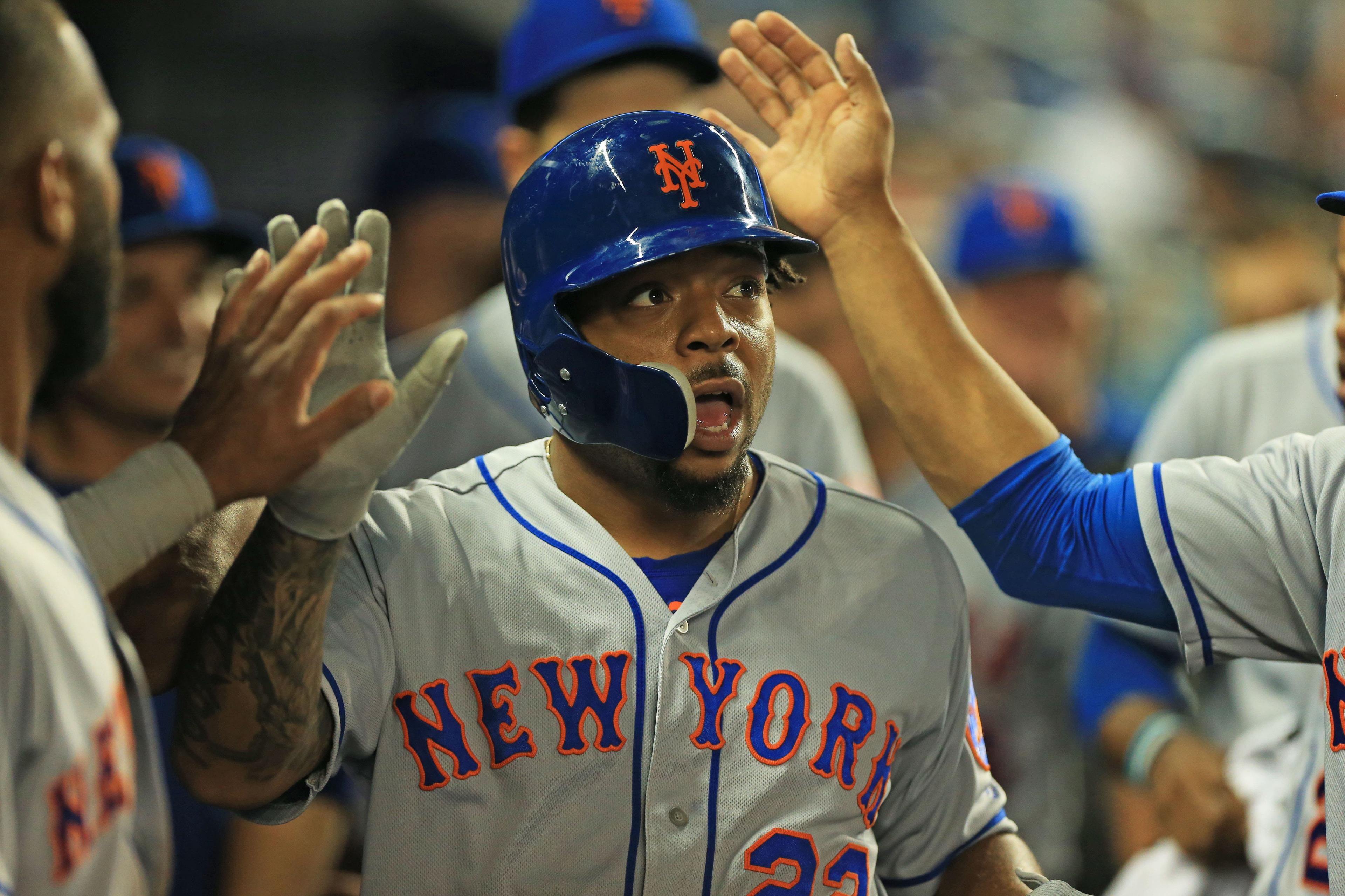 Apr 3, 2019; Miami, FL, USA; New York Mets first baseman Dominic Smith (22) celebrates in the dugout after a single by catcher Wilson Ramos (not pictured) in the eight inning of the game against the Miami Marlins at Marlins Park. Mandatory Credit: Sam Navarro-USA TODAY Sports / Sam Navarro