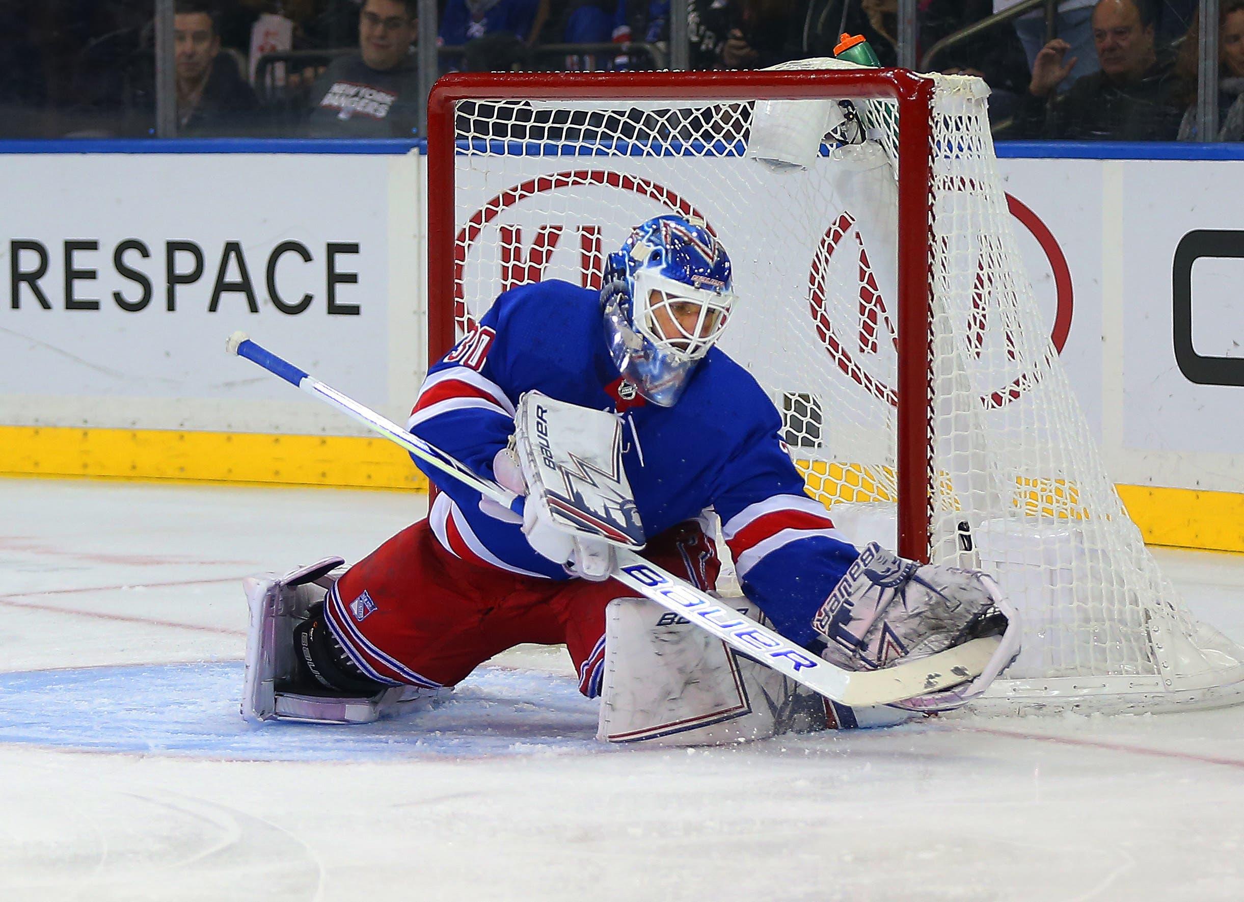 New York Rangers goaltender Henrik Lundqvist makes a save against the Buffalo Sabres during the first period at Madison Square Garden. / Andy Marlin/USA TODAY Sports