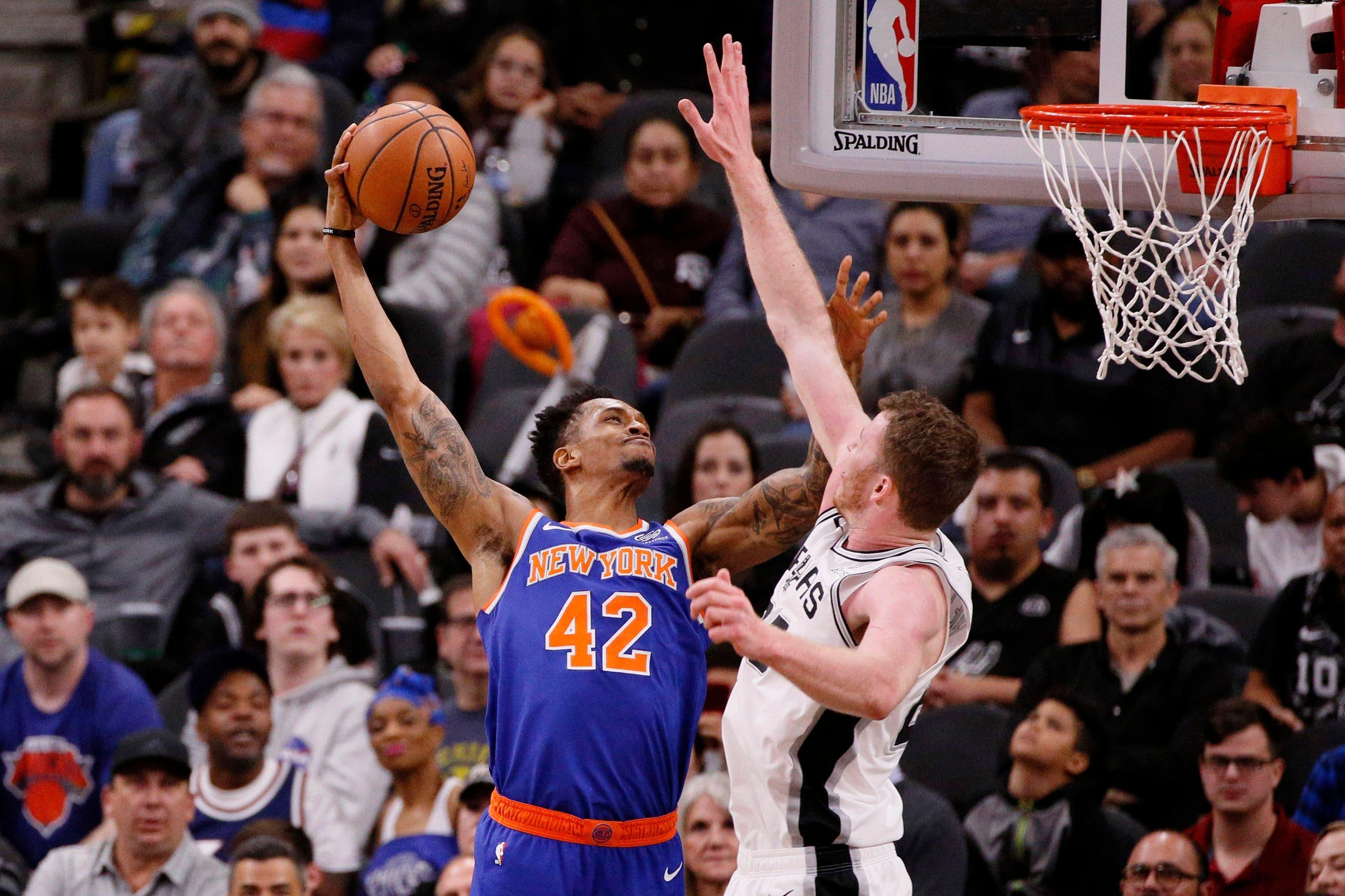 Mar 15, 2019; San Antonio, TX, USA; New York Knicks small forward Lance Thomas (42) dunks over San Antonio Spurs center Jakob Poeltl (right) during the first half at AT&T Center. Mandatory Credit: Soobum Im-USA TODAY Sports / Soobum Im