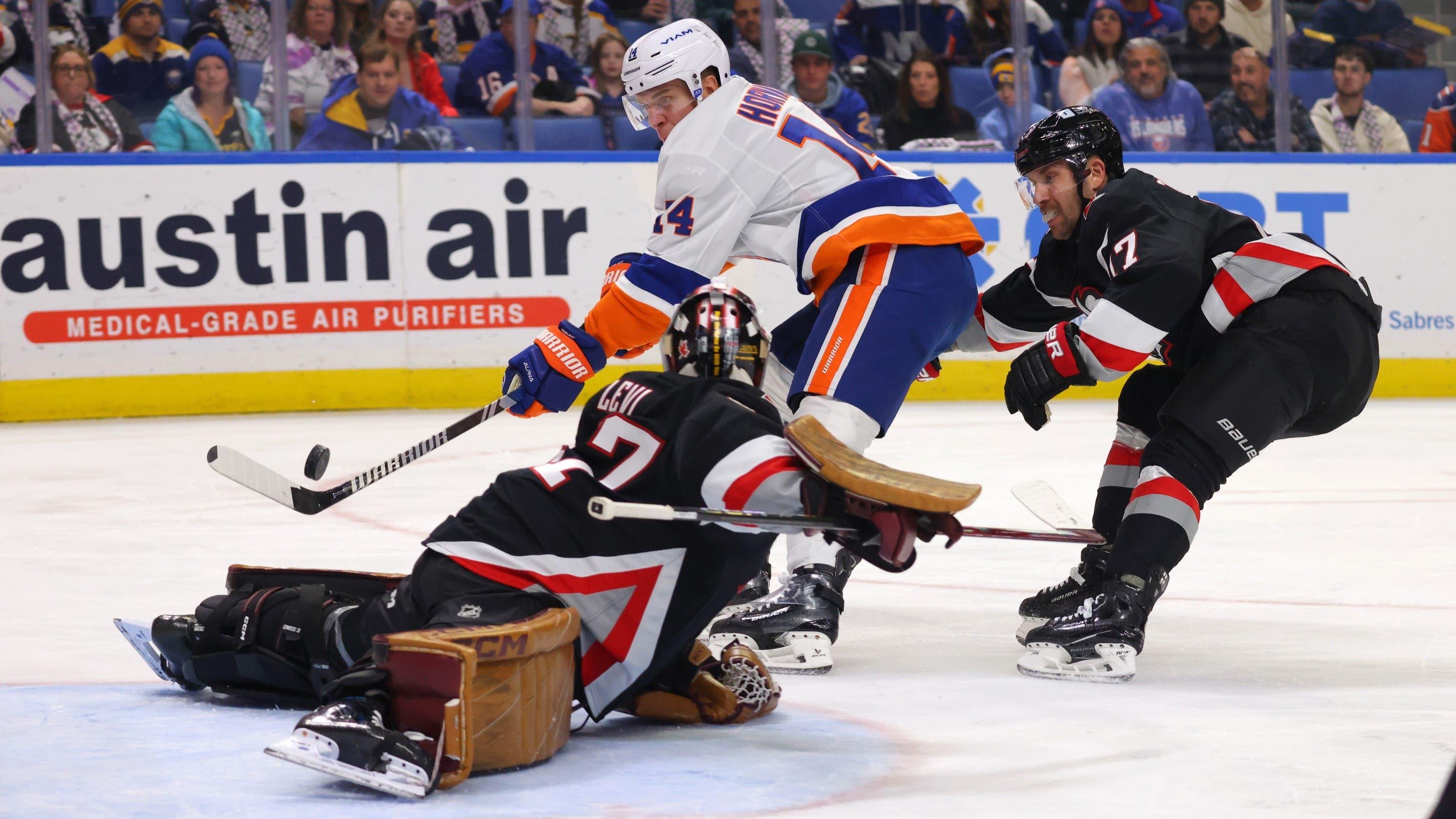 Nov 1, 2024; Buffalo, New York, USA; New York Islanders center Bo Horvat (14) scores a goal on Buffalo Sabres goaltender Devon Levi (27) during the first period at KeyBank Center. / Timothy T. Ludwig-Imagn Images