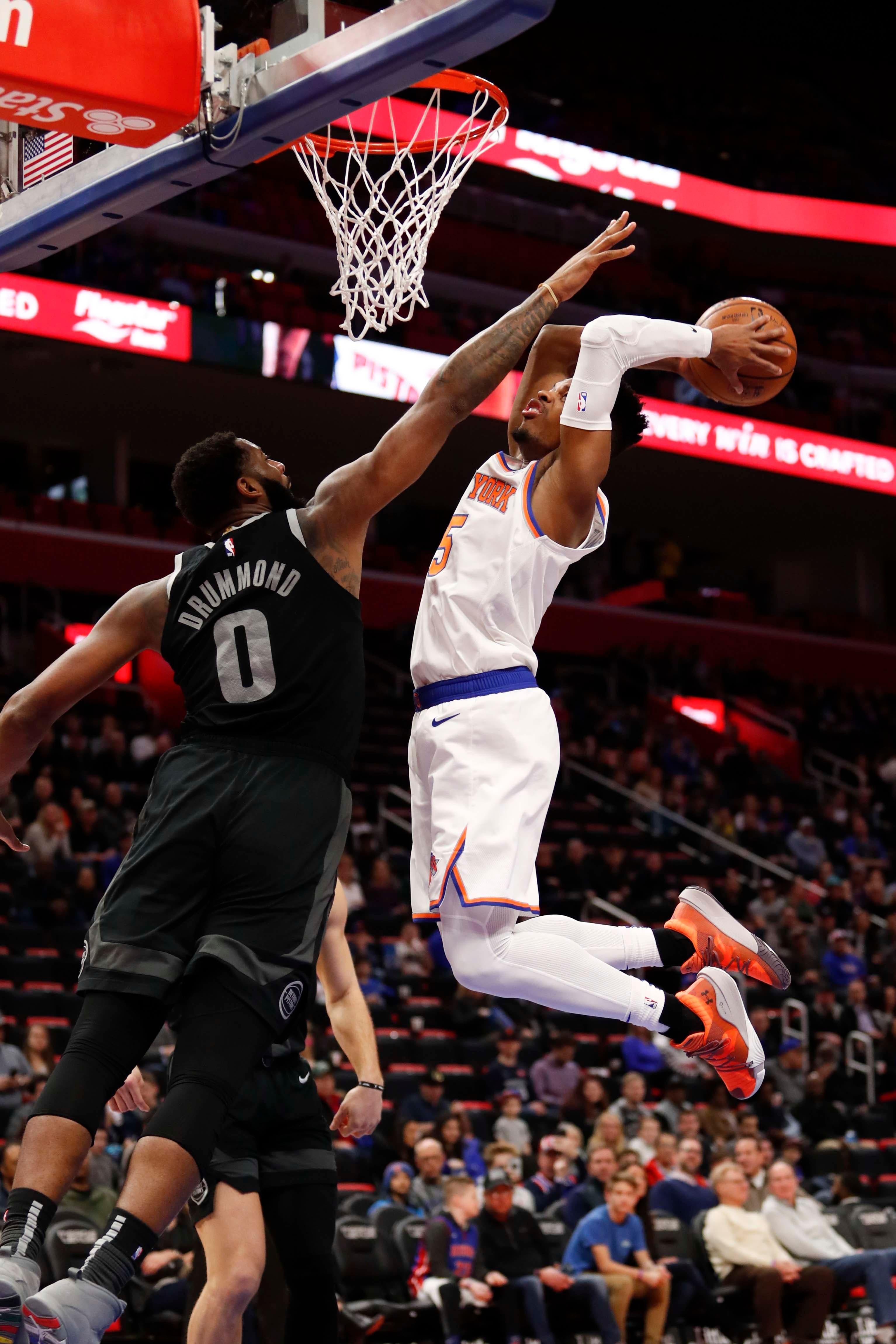 Feb 8, 2019; Detroit, MI, USA; New York Knicks guard Dennis Smith Jr. (5) attempts a dunk against Detroit Pistons center Andre Drummond (0) during the first quarter at Little Caesars Arena. Mandatory Credit: Raj Mehta-USA TODAY Sports / Raj Mehta