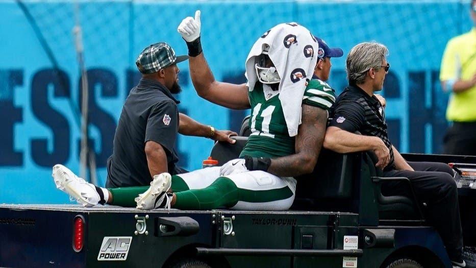 New York Jets linebacker Jermaine Johnson (11) exits the field after an injury during the third quarter against the Tennessee Titans at Nissan Stadium in Nashville, Tenn., Sunday, Sept. 15, 2024.