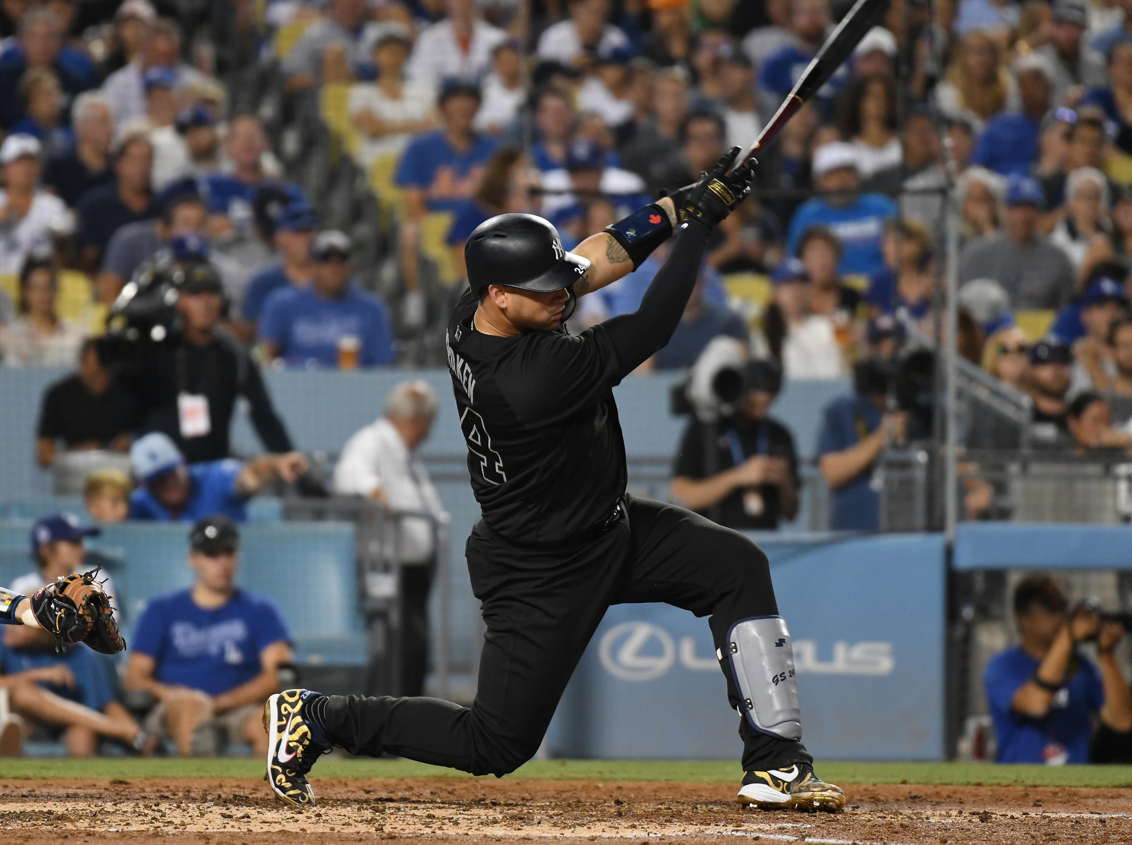 Aug 23, 2019; Los Angeles, CA, USA; New York Yankees catcher Gary Sanchez (24) hits a solo home run in the third inning against the Los Angeles Dodgers during an MLB Players' Weekend game at Dodger Stadium. Mandatory Credit: Richard Mackson-USA TODAY Sports