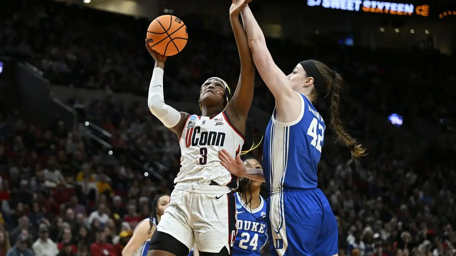 Mar 30, 2024; Portland, OR, USA; UConn Huskies forward Aaliyah Edwards (3) drives to the basket during the first half against Duke Blue Devils center Kennedy Brown (42) in the semifinals of the Portland Regional of the 2024 NCAA Tournament at the Moda Center. / Troy Wayrynen-USA TODAY Sports
