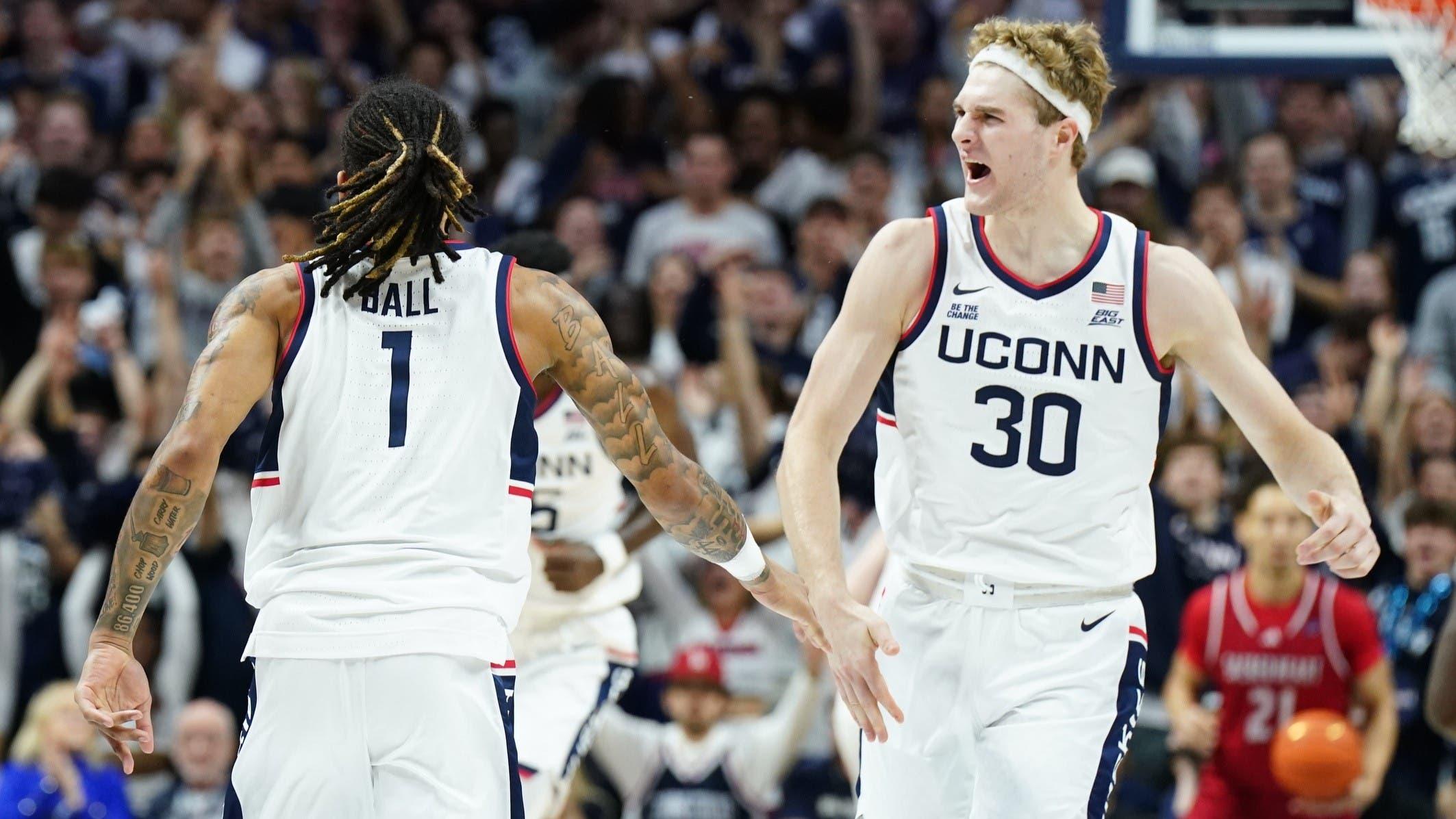 Nov 6, 2024; Storrs, Connecticut, USA; Connecticut Huskies forward Liam McNeeley (30) react after guard Solo Ball (1) makes a three point basket against the Sacred Heart Pioneers in the first half at Harry A. Gampel Pavilion. / David Butler II-Imagn Images